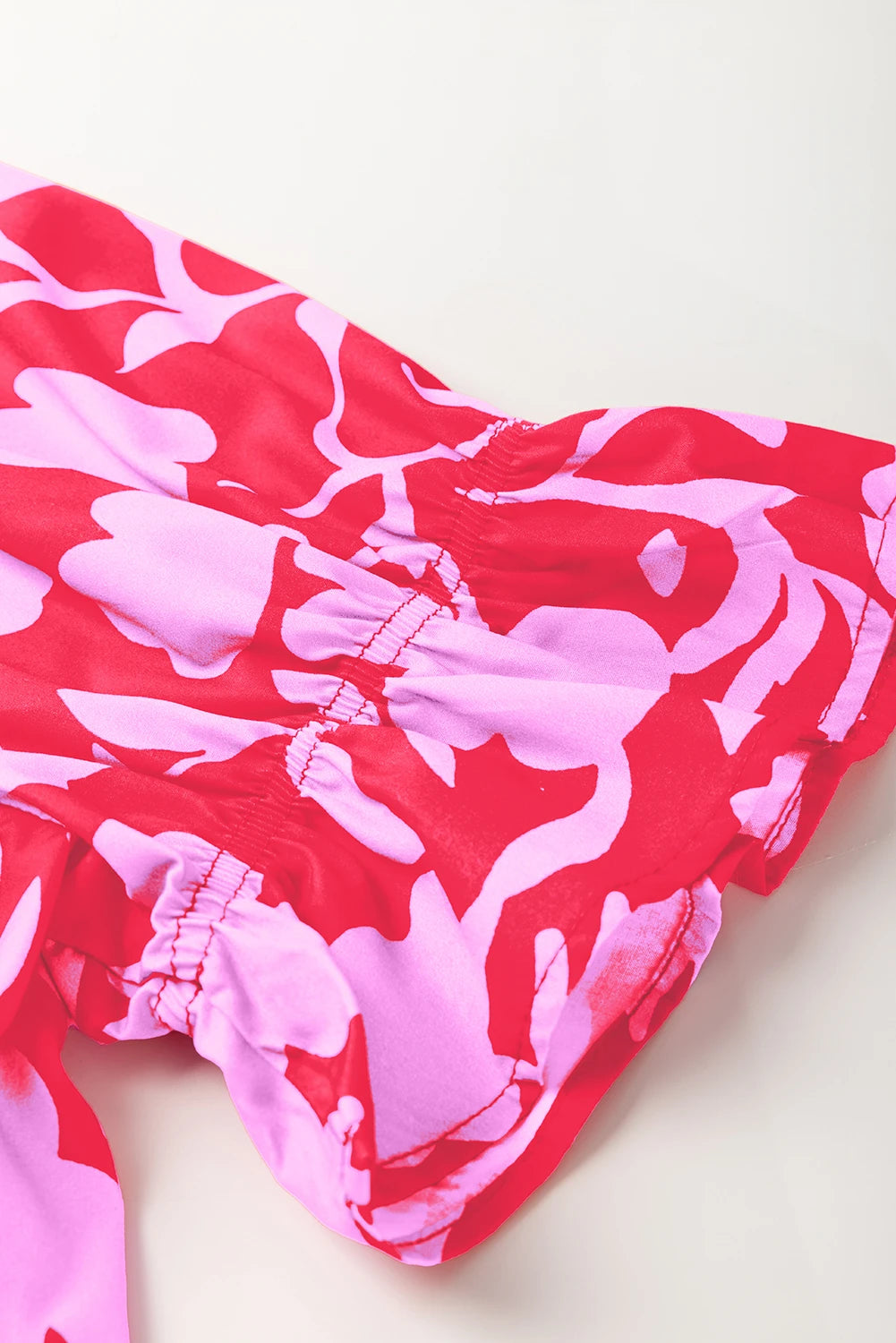 Red floral split V-neck ruffled short sleeve blouse top by Modern Grace, featuring a feminine design and lightweight fabric.