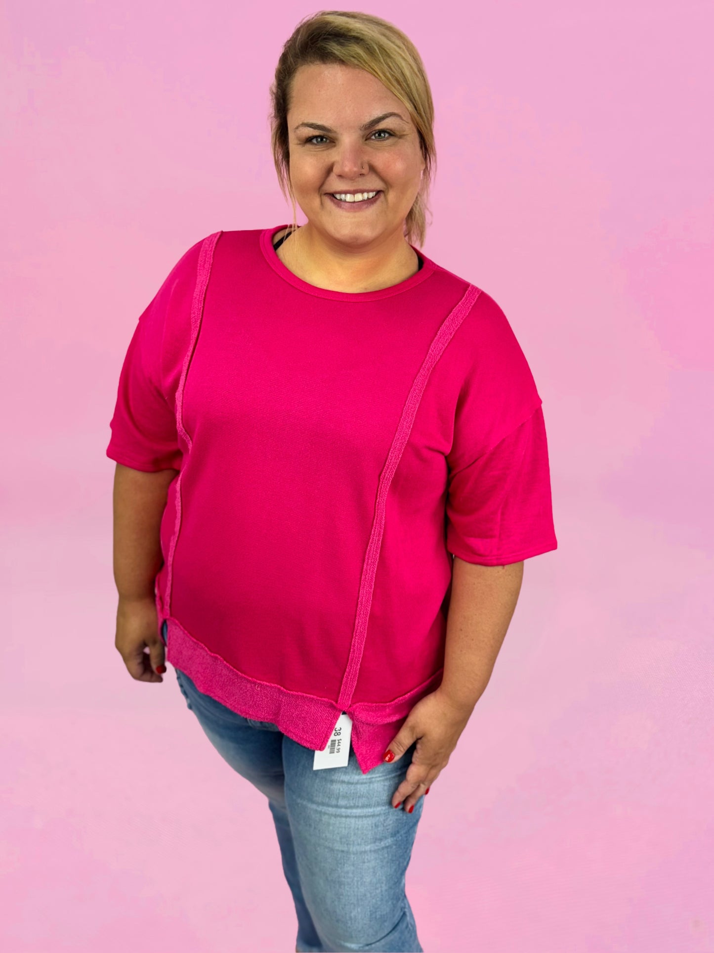 Modern Grace curvy fuchsia solid short sleeve relaxed fit top displayed on a model with casual styling.
