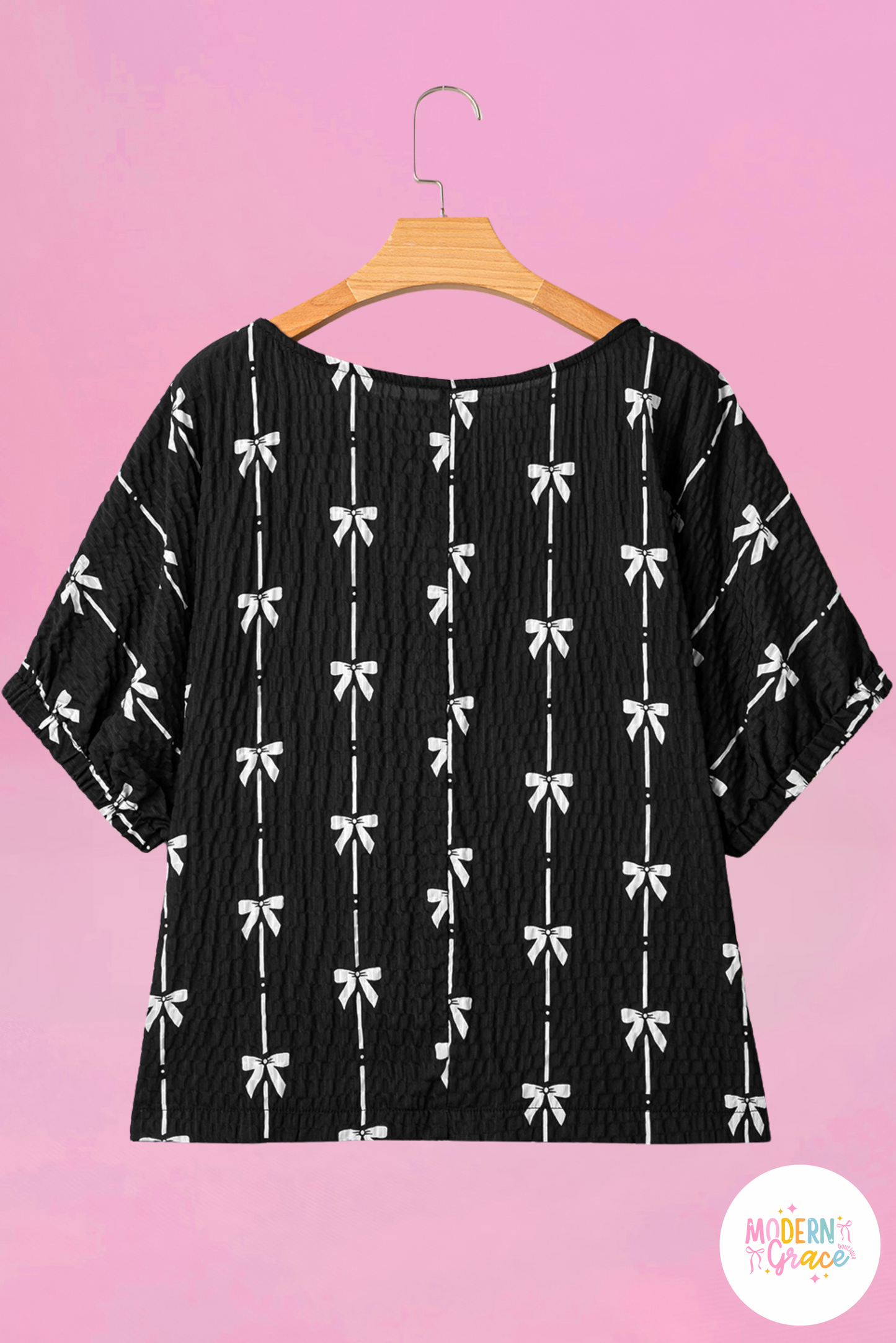 Black puff short sleeve top with bow print from Modern Grace, featuring a stylish and feminine design.