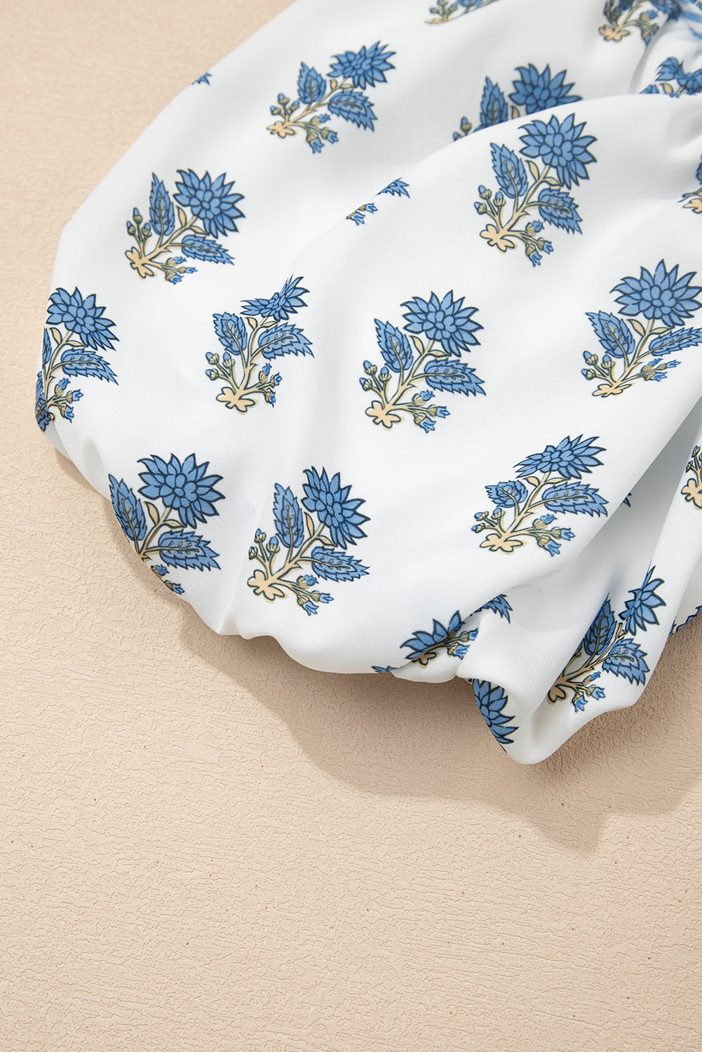 Sky blue floral puff sleeve mini dress with tied neckline and pockets by Modern Grace, featuring a stylish floral pattern.