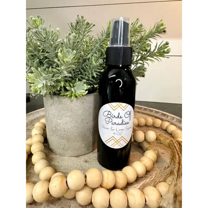Modern Grace Birds of Paradise Room and Linen Spray bottle with floral design, showcasing its elegant home fragrance packaging.