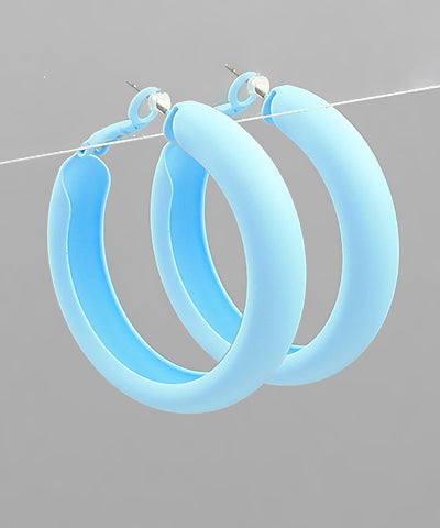 Color coated hoop earrings by Modern Grace featuring vibrant, glossy finishes and a classic circular design.