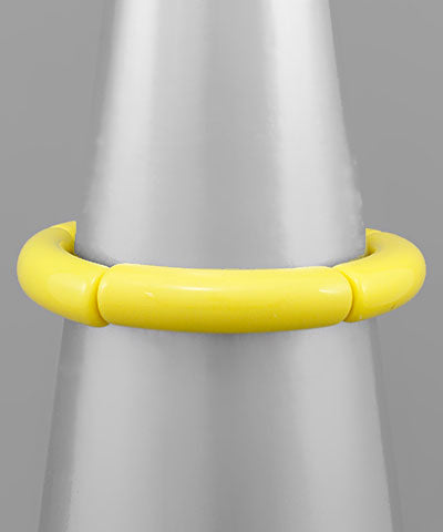 Modern Grace acrylic tube bracelet in three vibrant colors, featuring sleek cylindrical design and smooth finish.