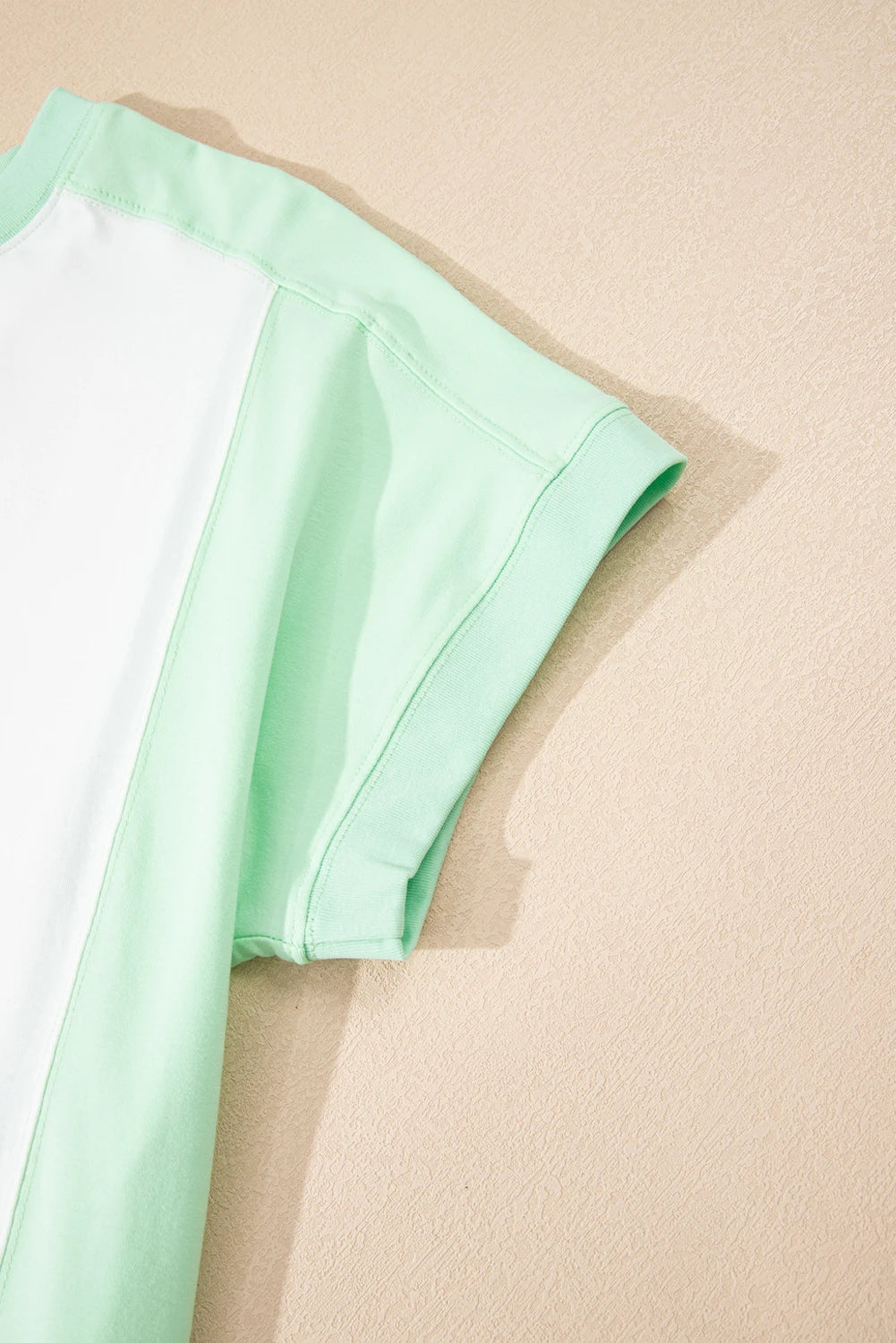 Light green color block crew neck T-shirt by Modern Grace with exposed seams and modern, casual style.
