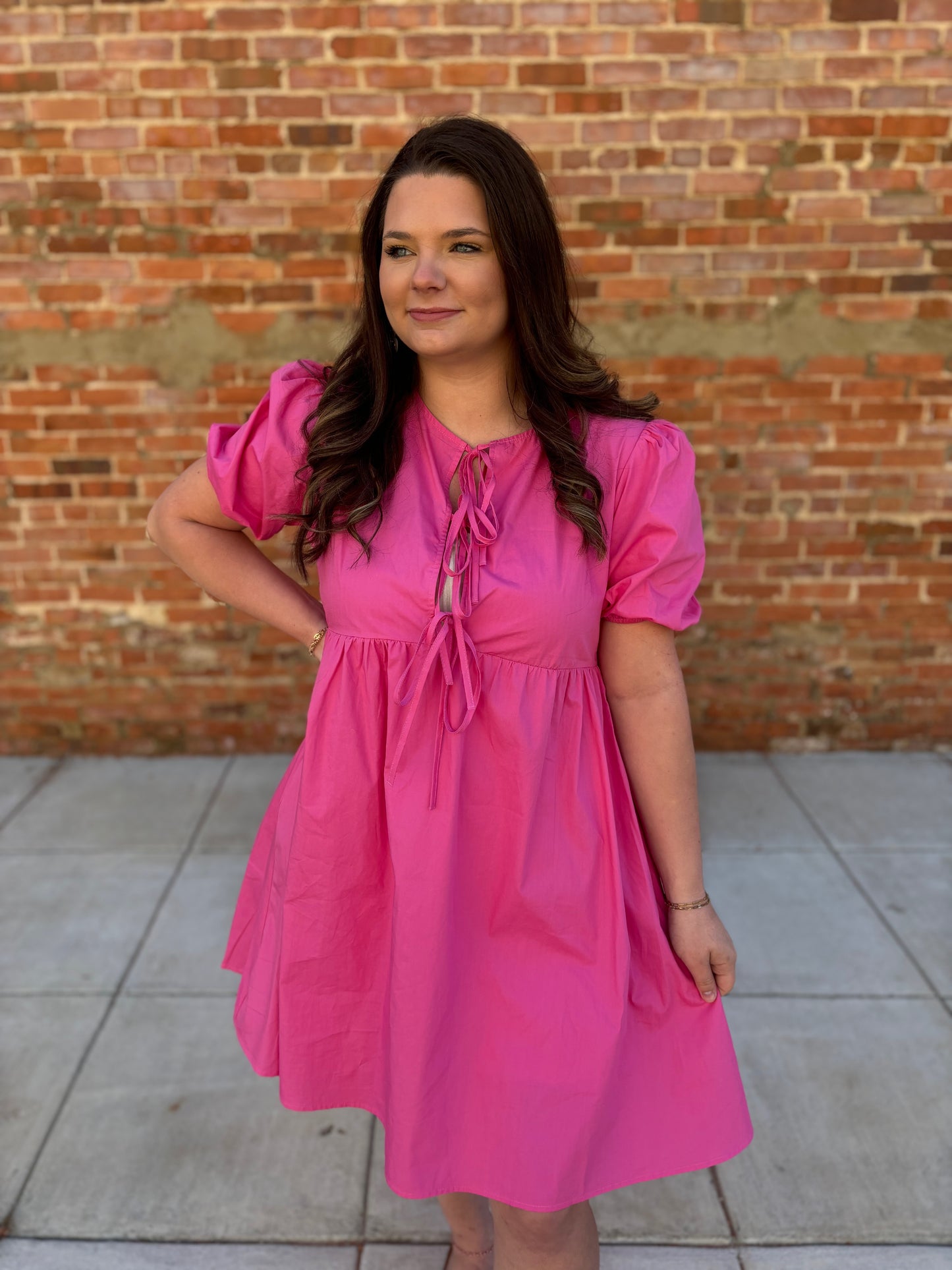 Solid pink puff sleeve bow dress by Modern Grace, featuring a feminine design with puff sleeves and a bow detail.