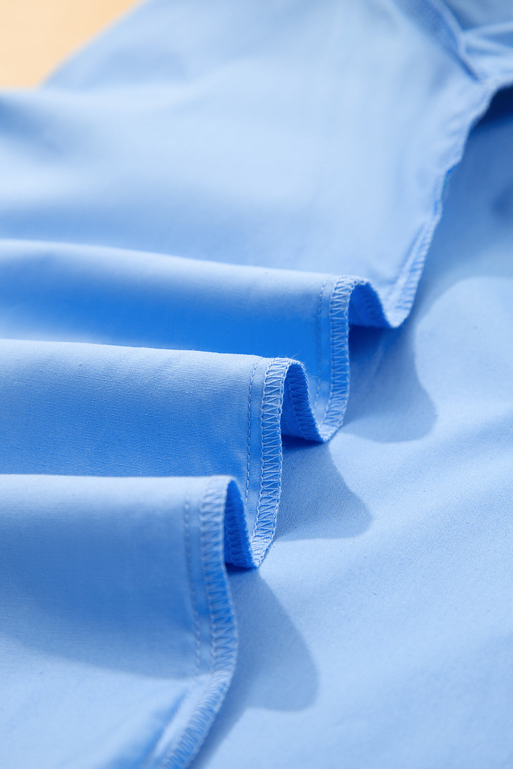 Sky blue striped V-neck blouse by Modern Grace with short puff sleeves, 100% cotton, stylish and lightweight for casual wear.