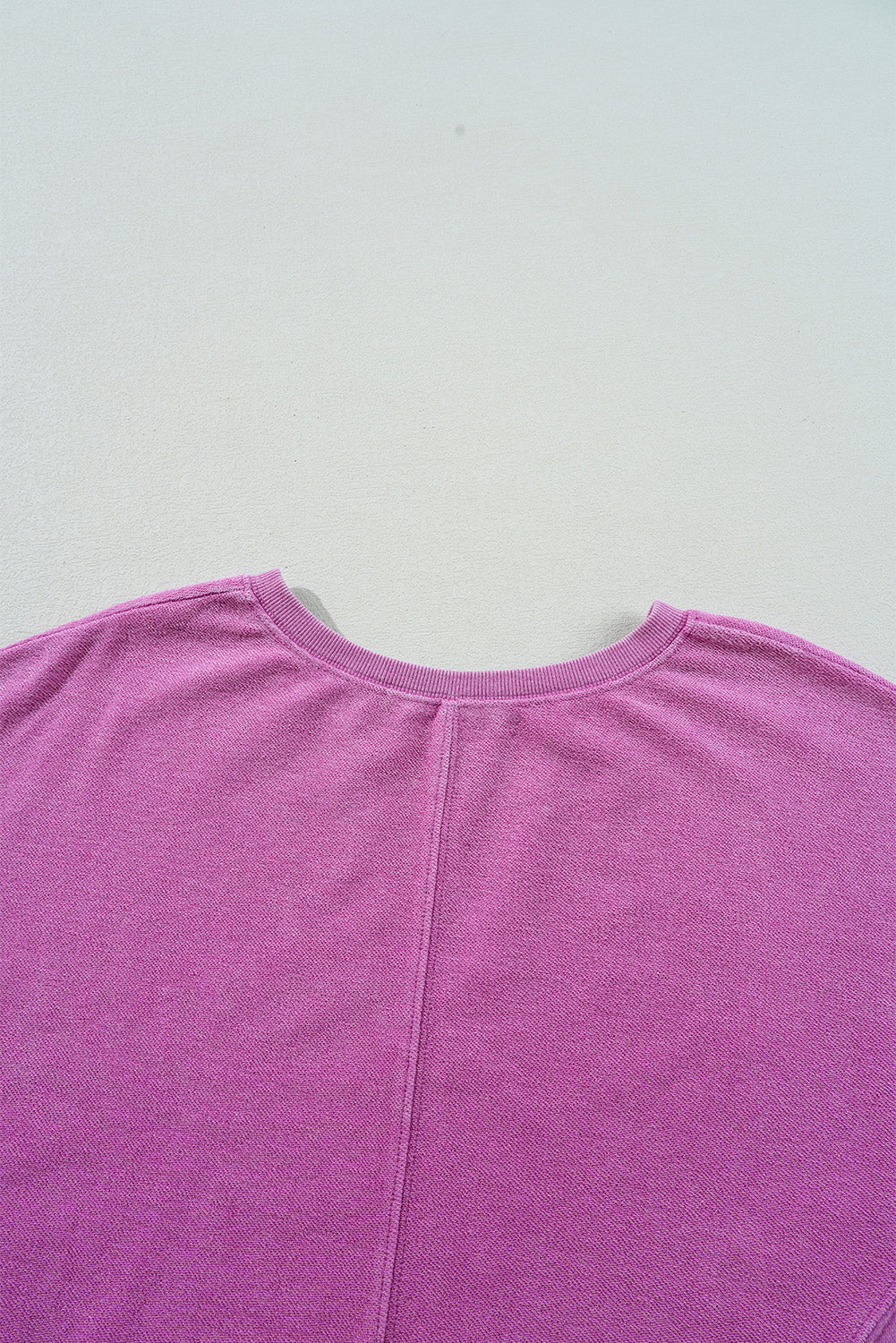 Bright pink solid color sweatshirt by Modern Grace featuring a notched neckline and drop shoulder design.
