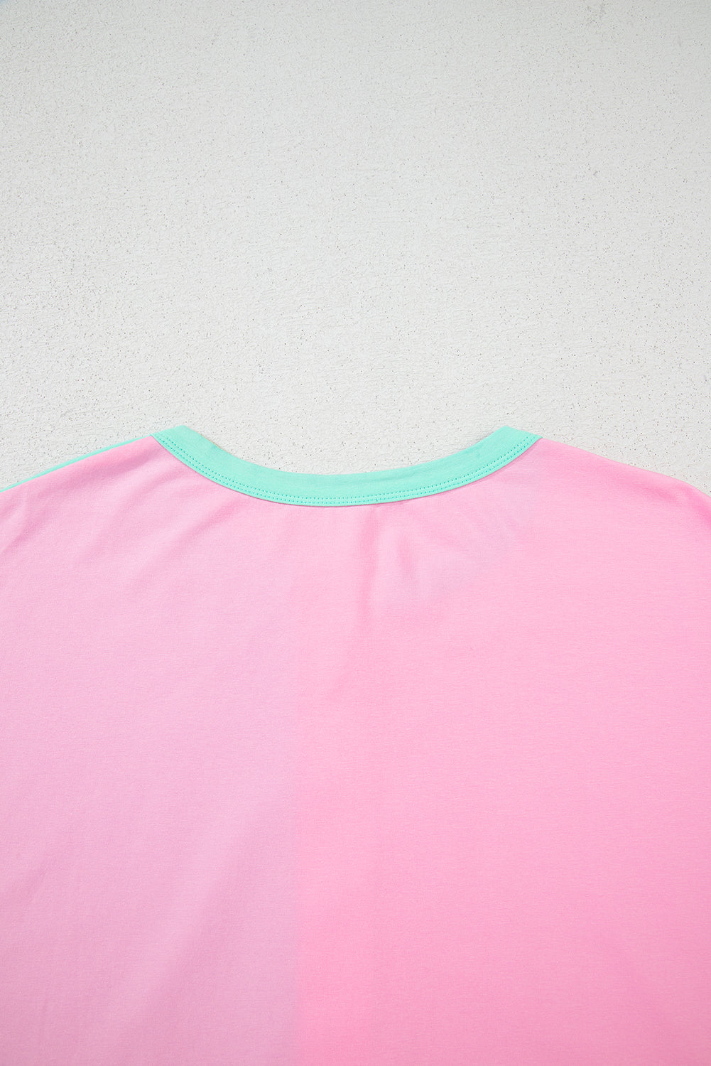 Mint green two-tone collared T-shirt with half buttons by Modern Grace, made of cotton and elastane, featuring a stylish neckline.