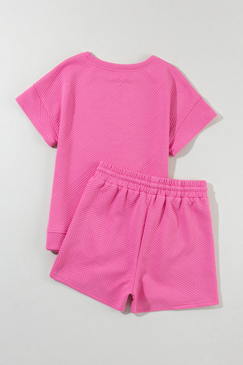 Strawberry pink two-piece drawstring shorts set by Modern Grace with textured fabric, includes matching shorts and top.