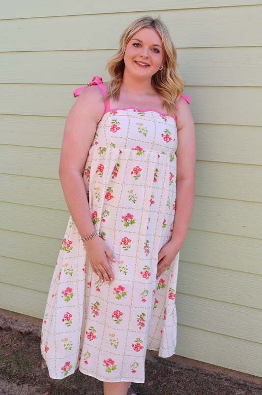 Pink floral tile pattern scalloped tie strap midi dress by Blu Pepper, showing the dress's pattern, scalloped edges, and tie straps.