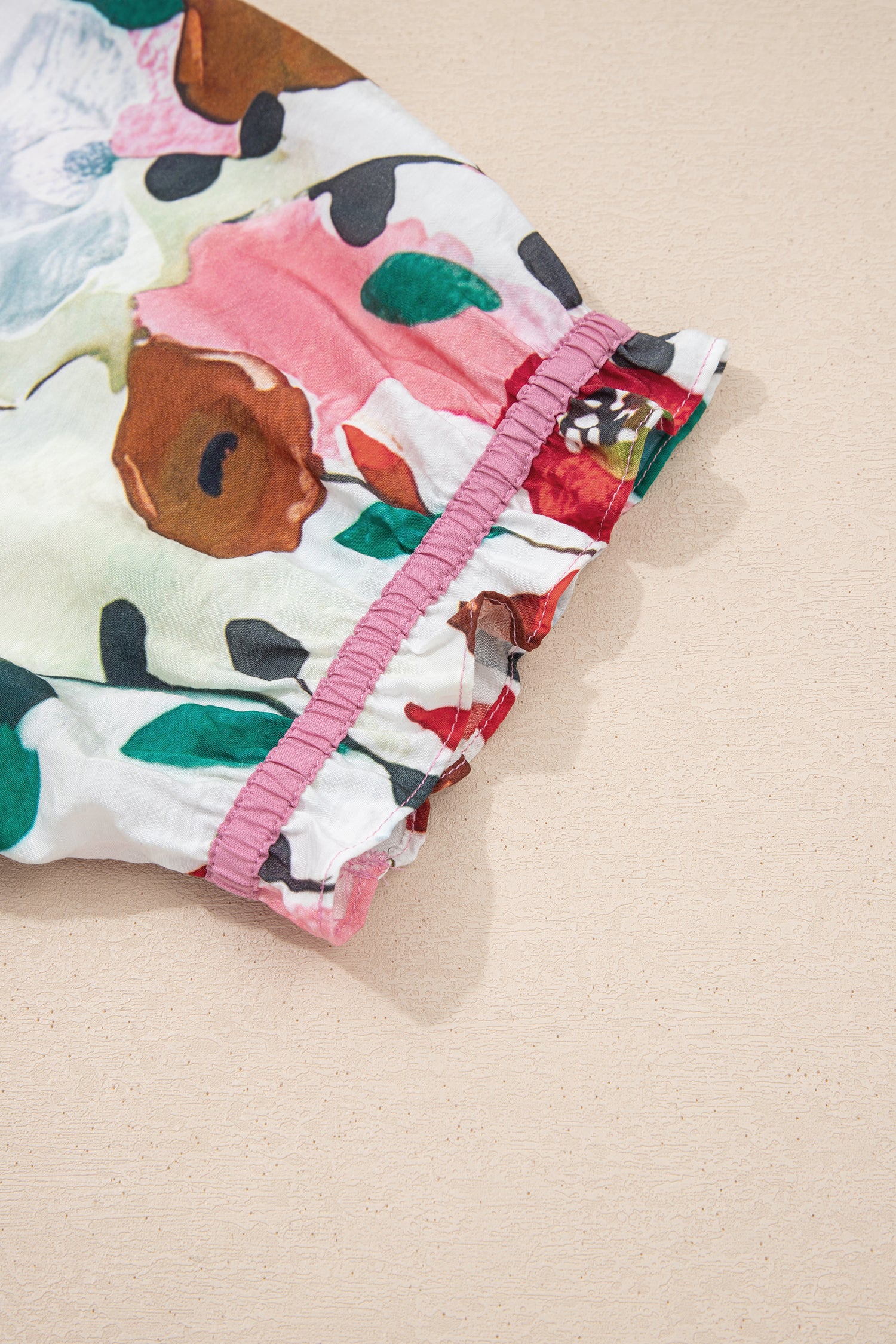 Pink V-neck plus size floral blouse with short puff sleeves by Modern Grace, featuring a stylish and comfortable fit.