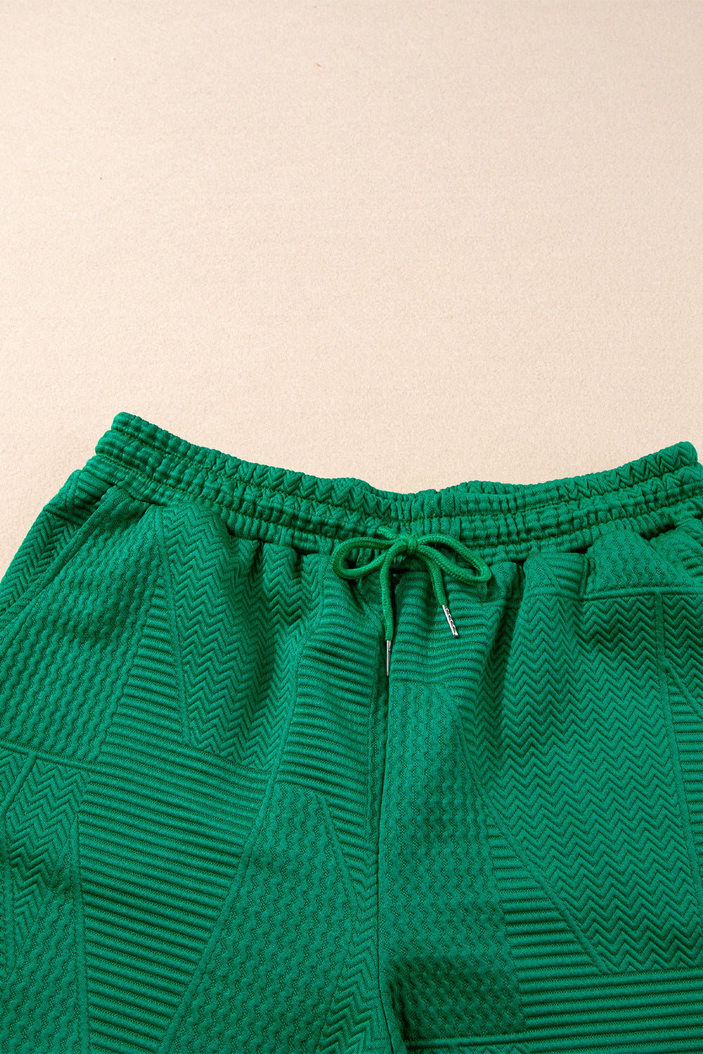Dark green textured ruffle split top with drawstring shorts, Modern Grace two-piece set, stylish and comfortable summer outfit.