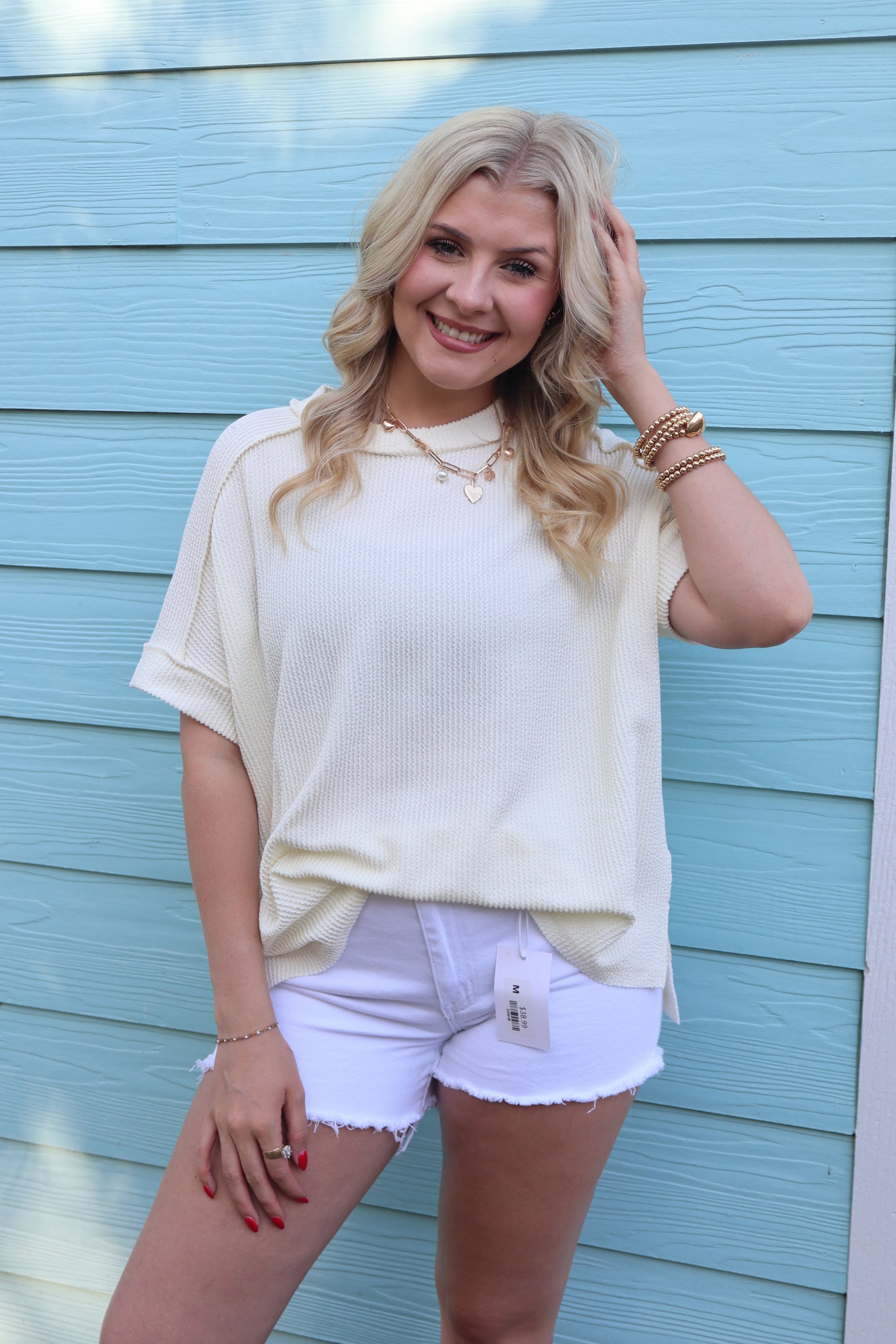 Cream Zenana raw edge top with raised rib cuff sleeves, featuring a stylish, casual design and textured fabric.