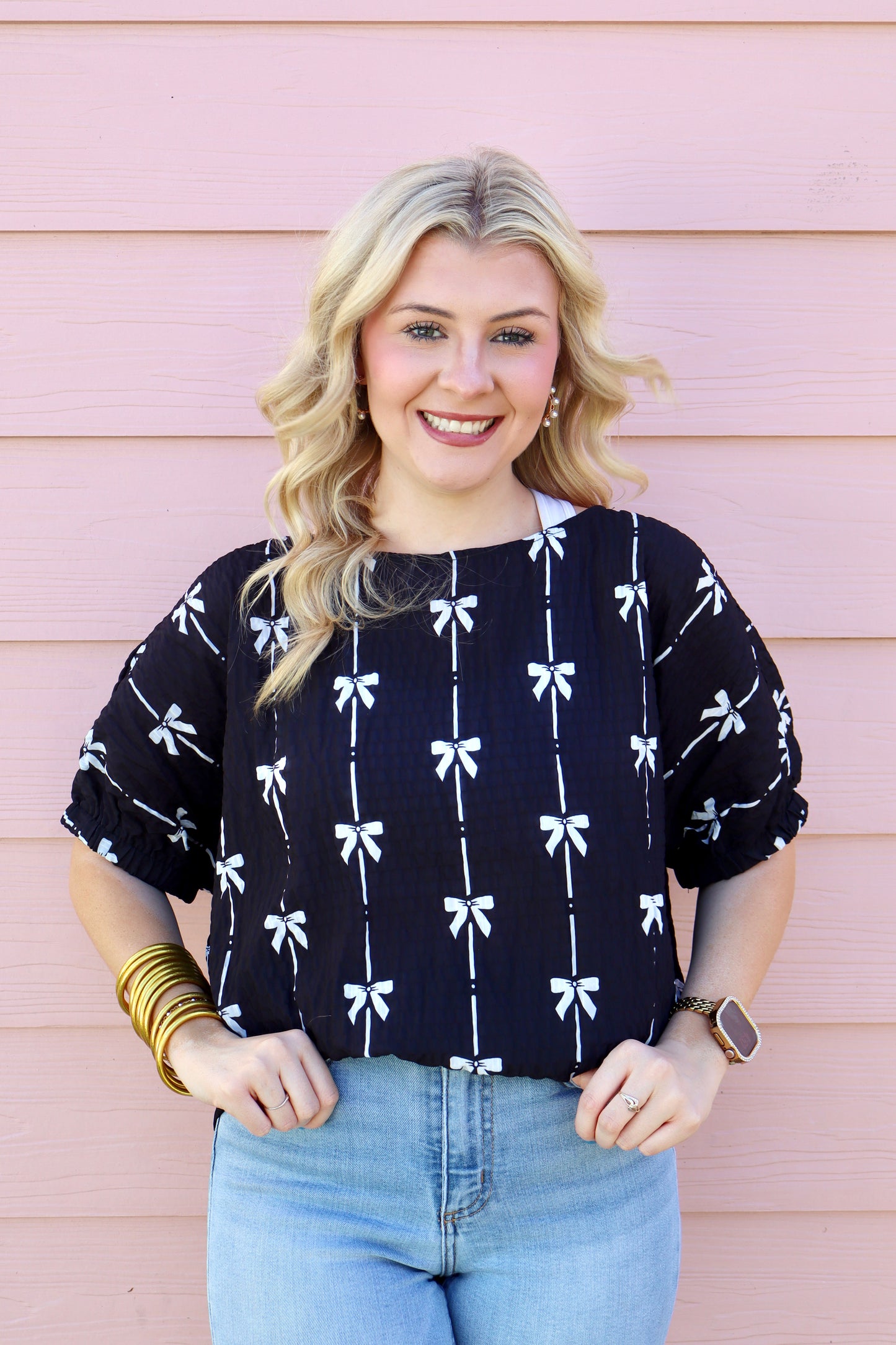 Black puff sleeve top with bow print from Modern Grace, featuring short sleeves and a stylish, feminine design.