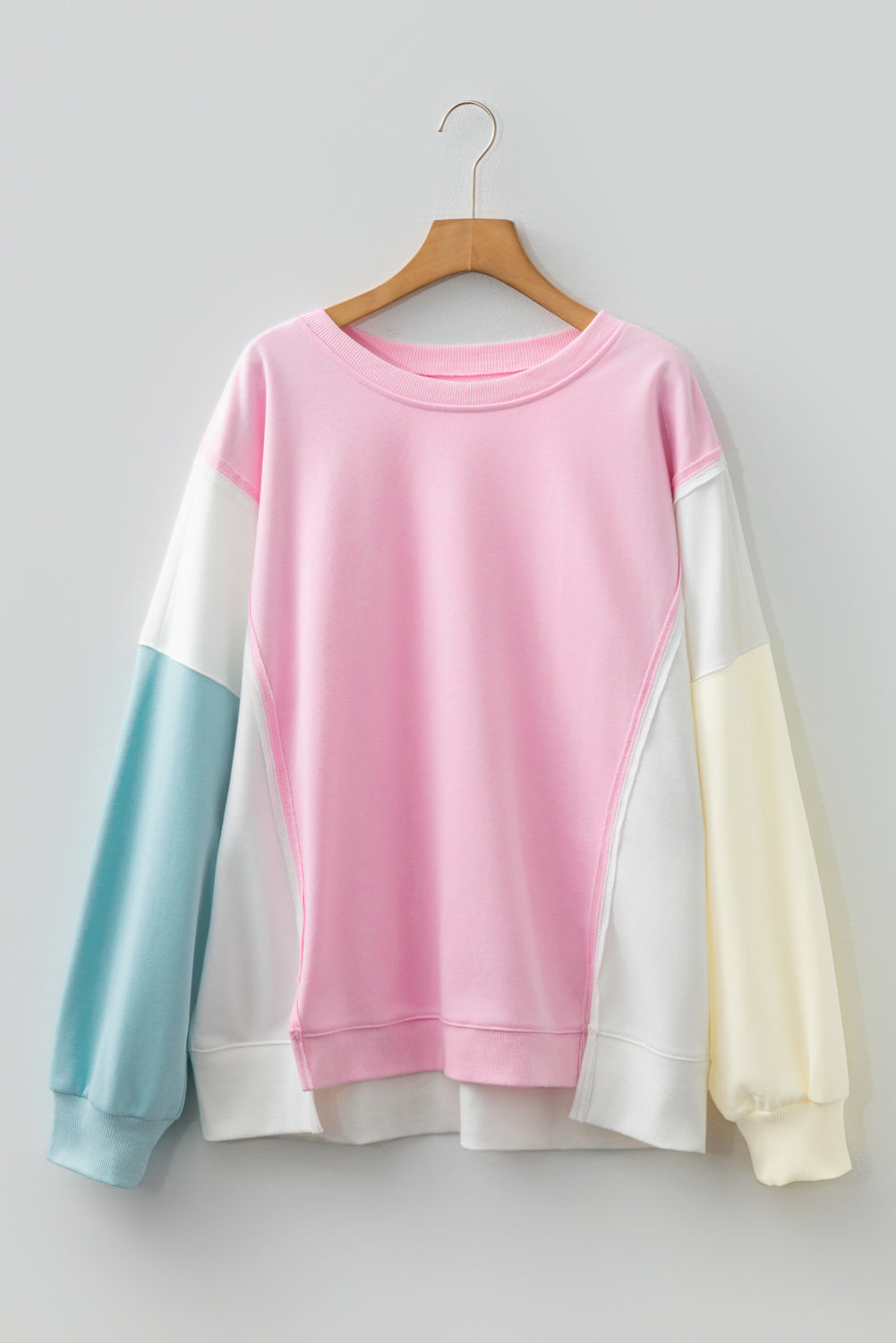 Plus size pink colorblock patchwork sweatshirt by Modern Grace featuring a cozy, stylish design with a curved fit.