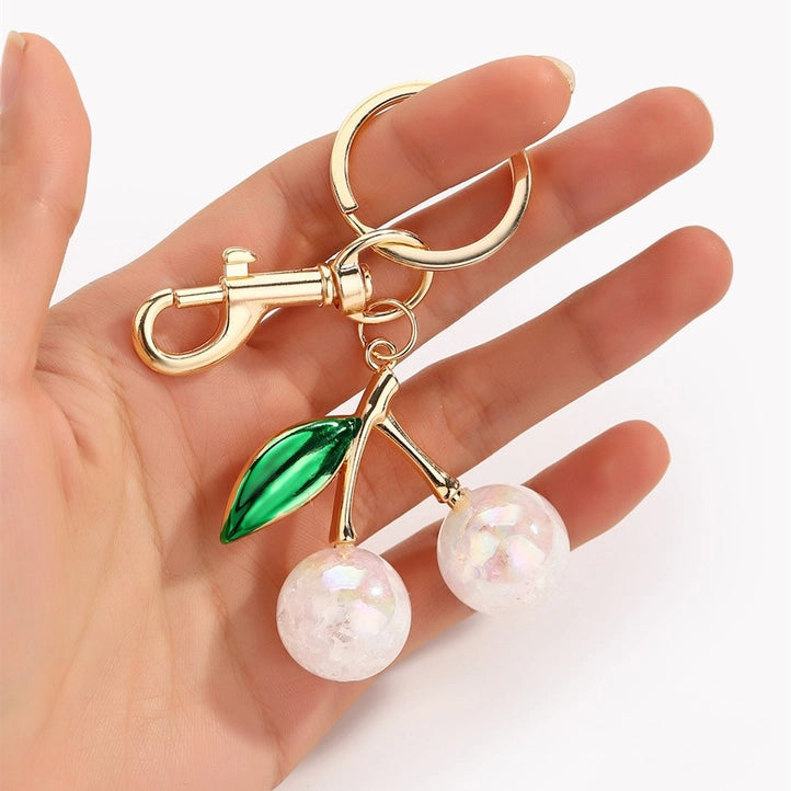 Modern Grace Pearlie Cherry Drop with Leaf keychain bag charm, featuring a cherry design and green leaf accent, accessory for bags.