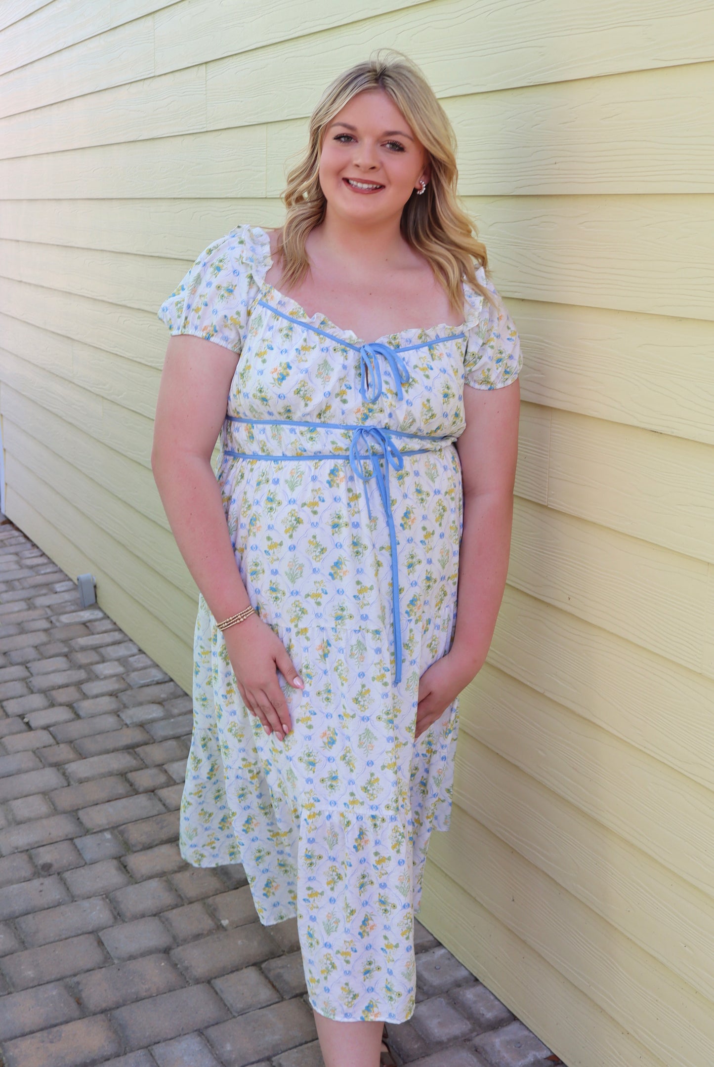 Blue floral tile print midi dress by Blu Pepper with contrast tie detail, flowing fabric and elegant design.