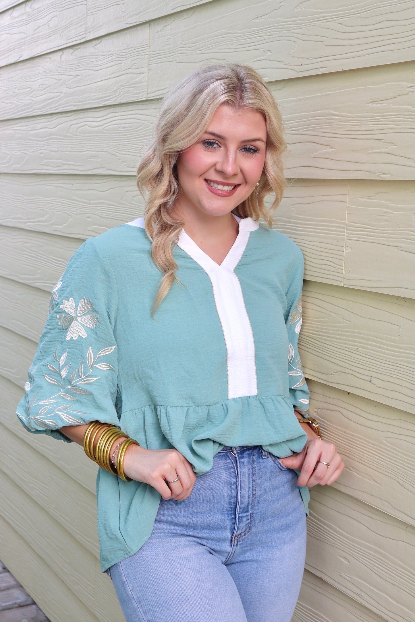 Sage green patchwork babydoll blouse with V-neck, embroidered details, and puff sleeves from Modern Grace.