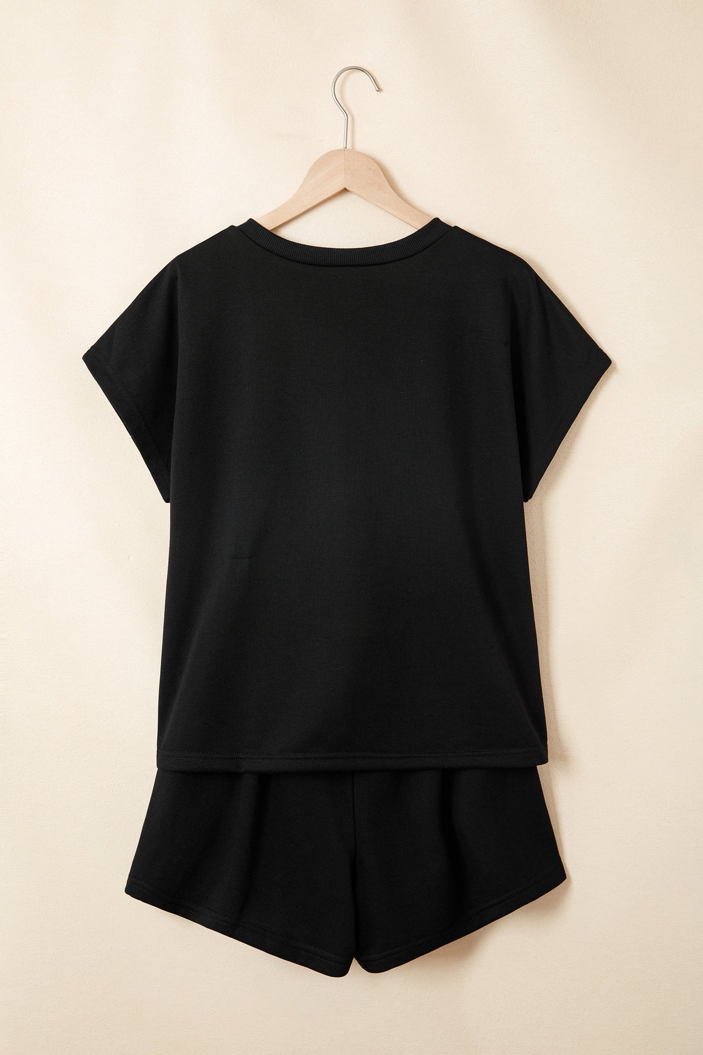 Modern Grace black leopard print V-neck loose tee and drawstring shorts two-piece set, casual and stylish for comfortable wear.