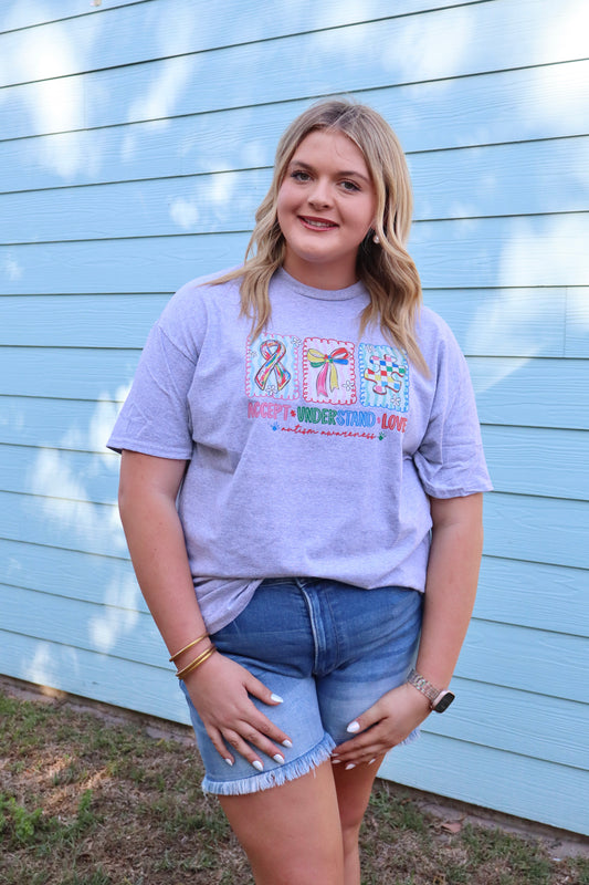 Modern Grace Heather Grey Autism Awareness T-shirt with short sleeves and awareness ribbon design, made from soft cotton fabric.