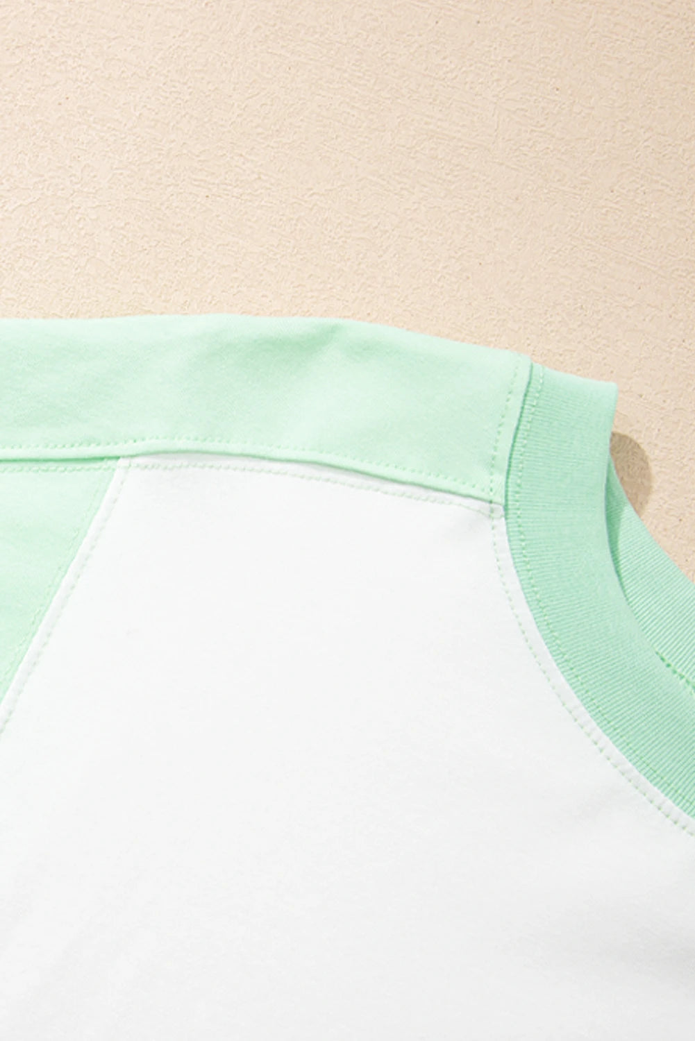 Light green color block crew neck T-shirt by Modern Grace with exposed seams, casual fit, and modern design.