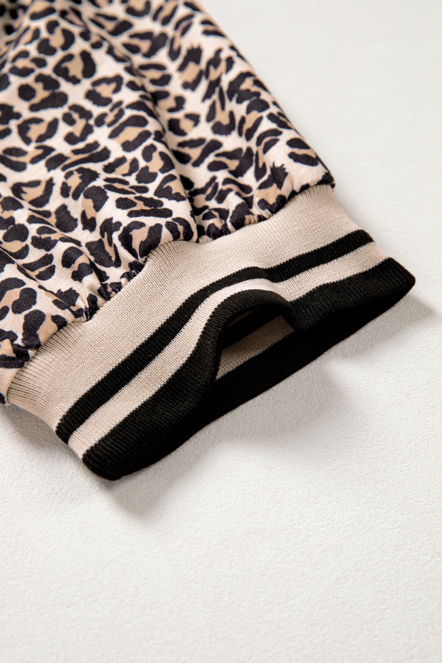 Modern Grace brown leopard print half zip short sleeve top with striped trim and patchwork details, stylish blouse for casual wear.