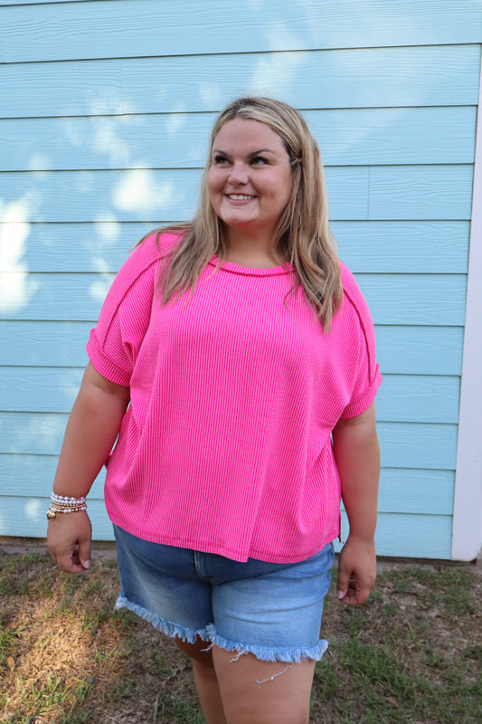 Modern Grace curvy hot pink ribbed cuff sleeve raw edge top with raised texture and casual style, shown on a model.