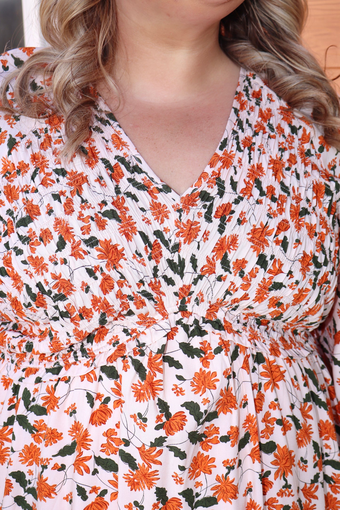 Modern Grace fall floral V-neck babydoll dress with long sleeves and smocked bust, featuring a flowy, feminine silhouette.