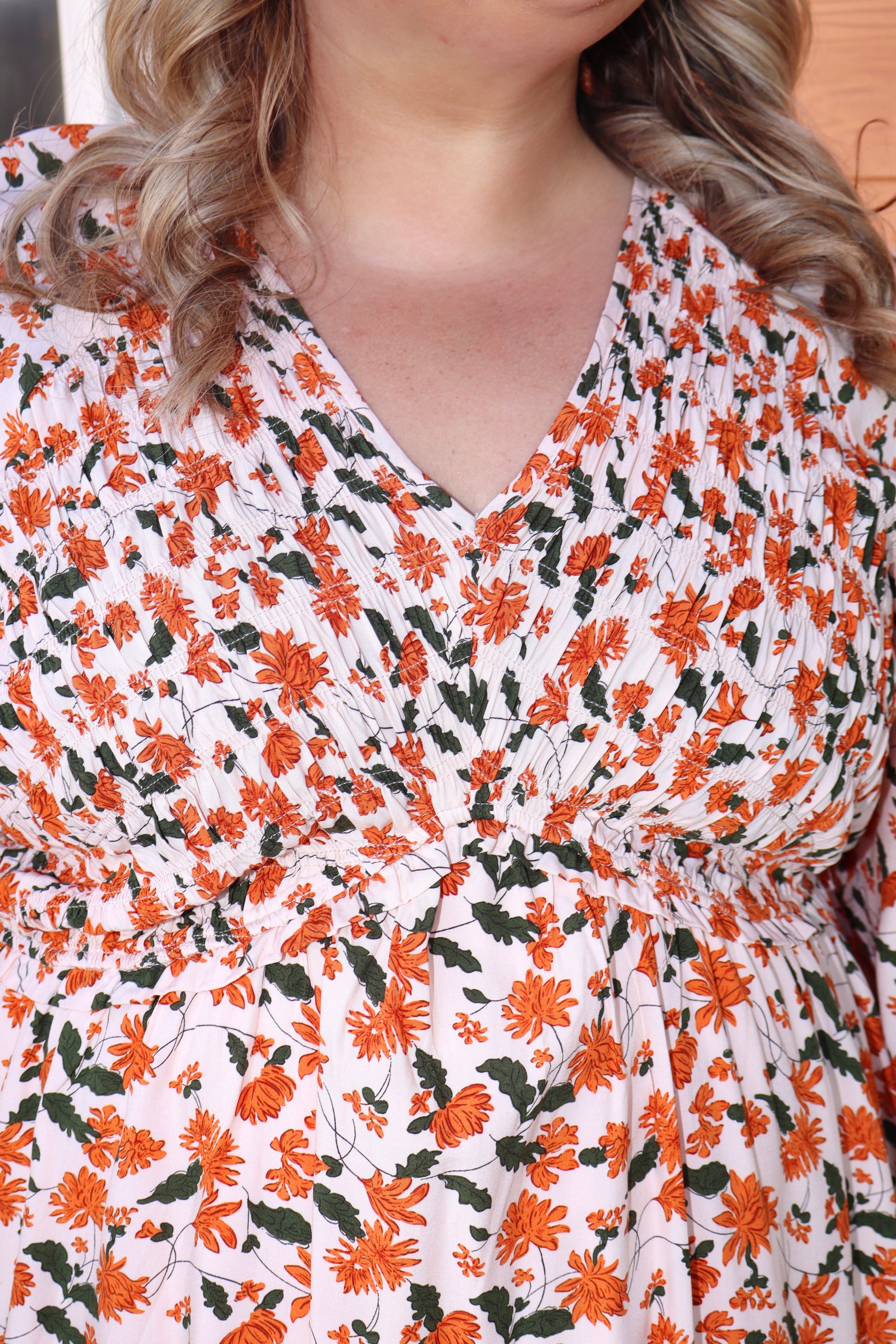 Modern Grace fall floral V-neck babydoll dress with long sleeves and smocked bust, featuring a flowy, feminine silhouette.