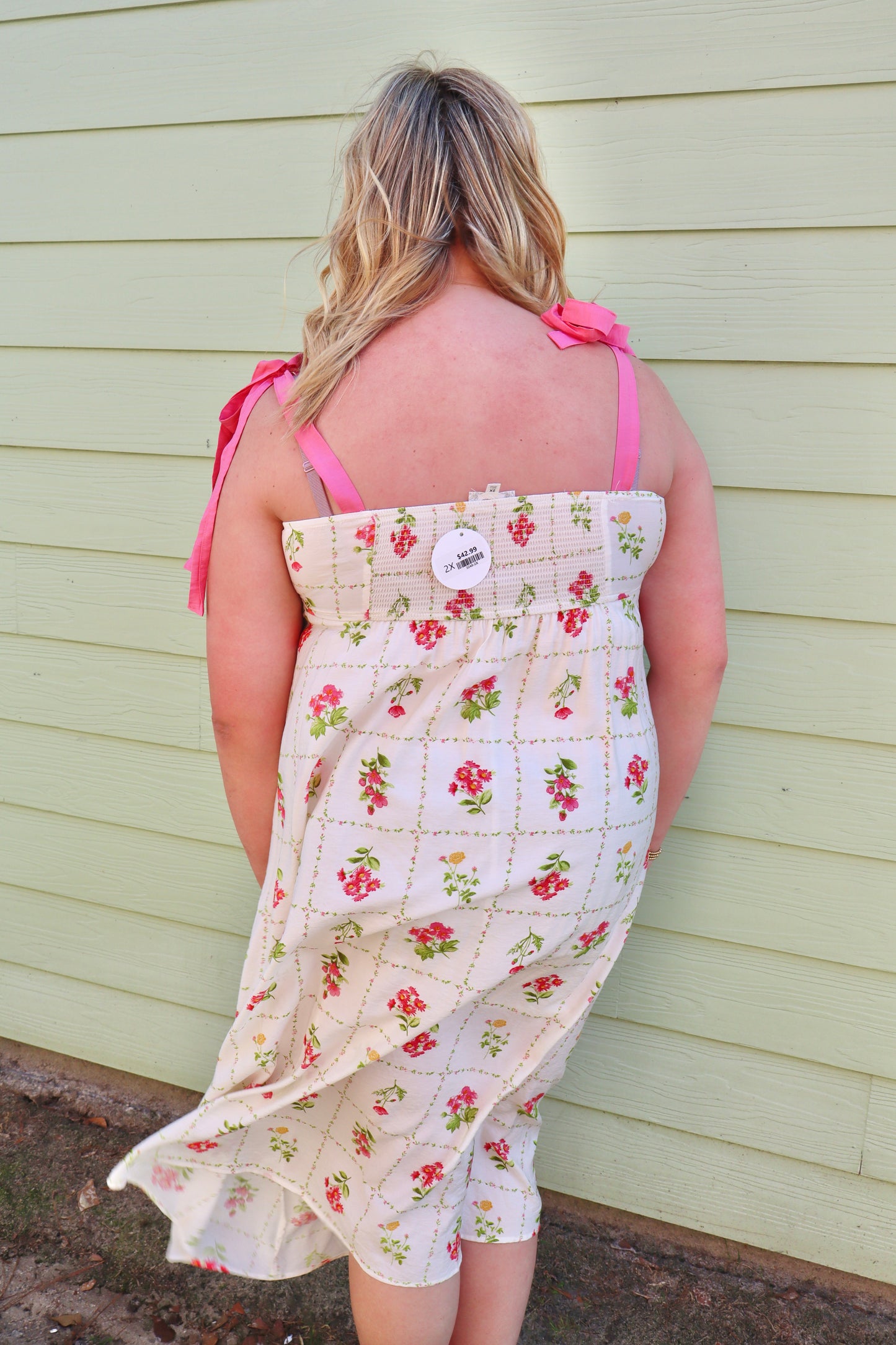 Pink floral tile pattern midi dress by Blu Pepper with scalloped tie straps and a flowy silhouette.