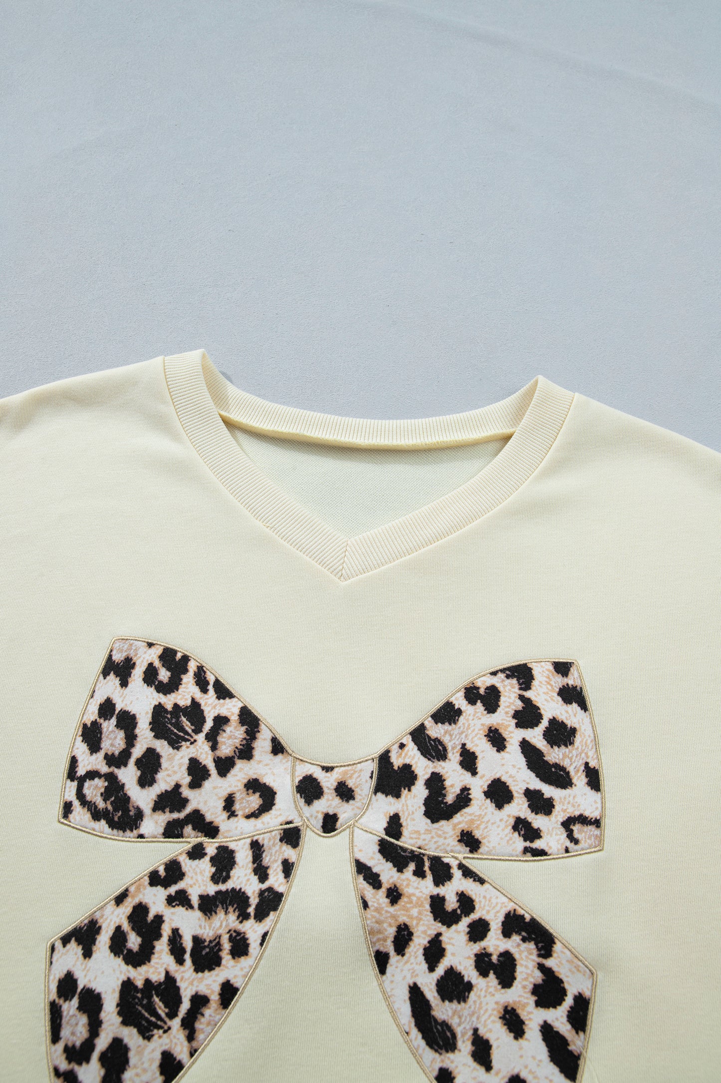 White contrast leopard bow V-neck loose tee and drawstring shorts two-piece set by Modern Grace, casual and stylish outfit.