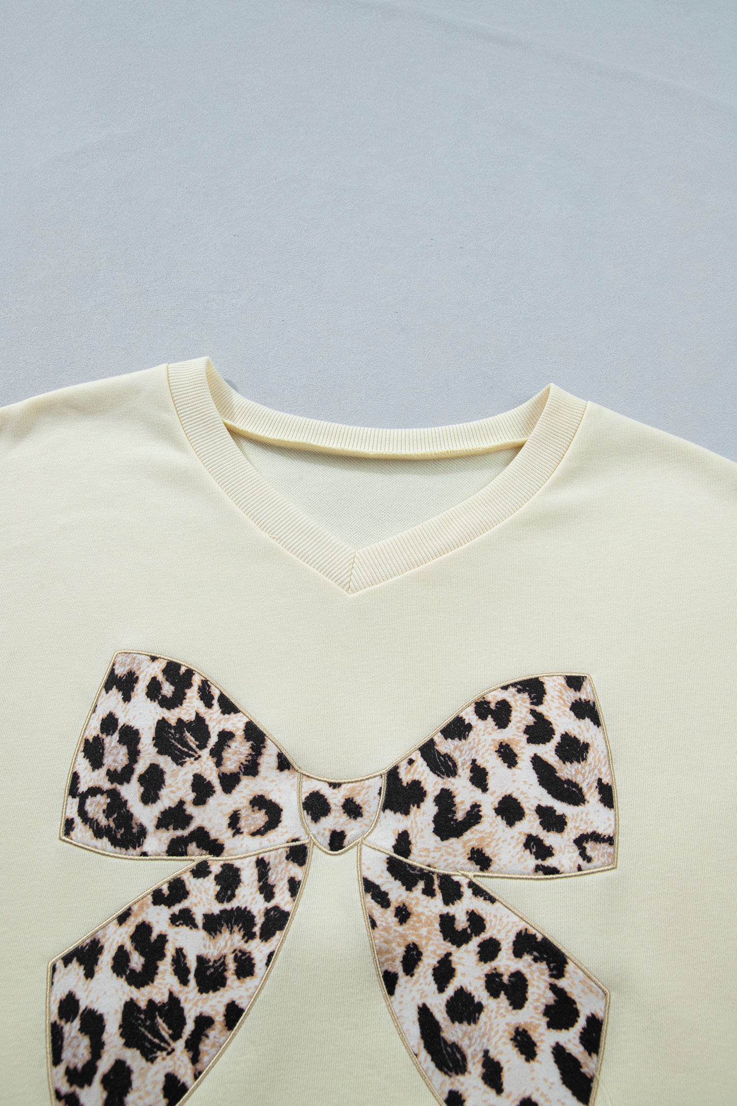 White contrast leopard bow V-neck loose tee and drawstring shorts two-piece set by Modern Grace, casual and stylish outfit.