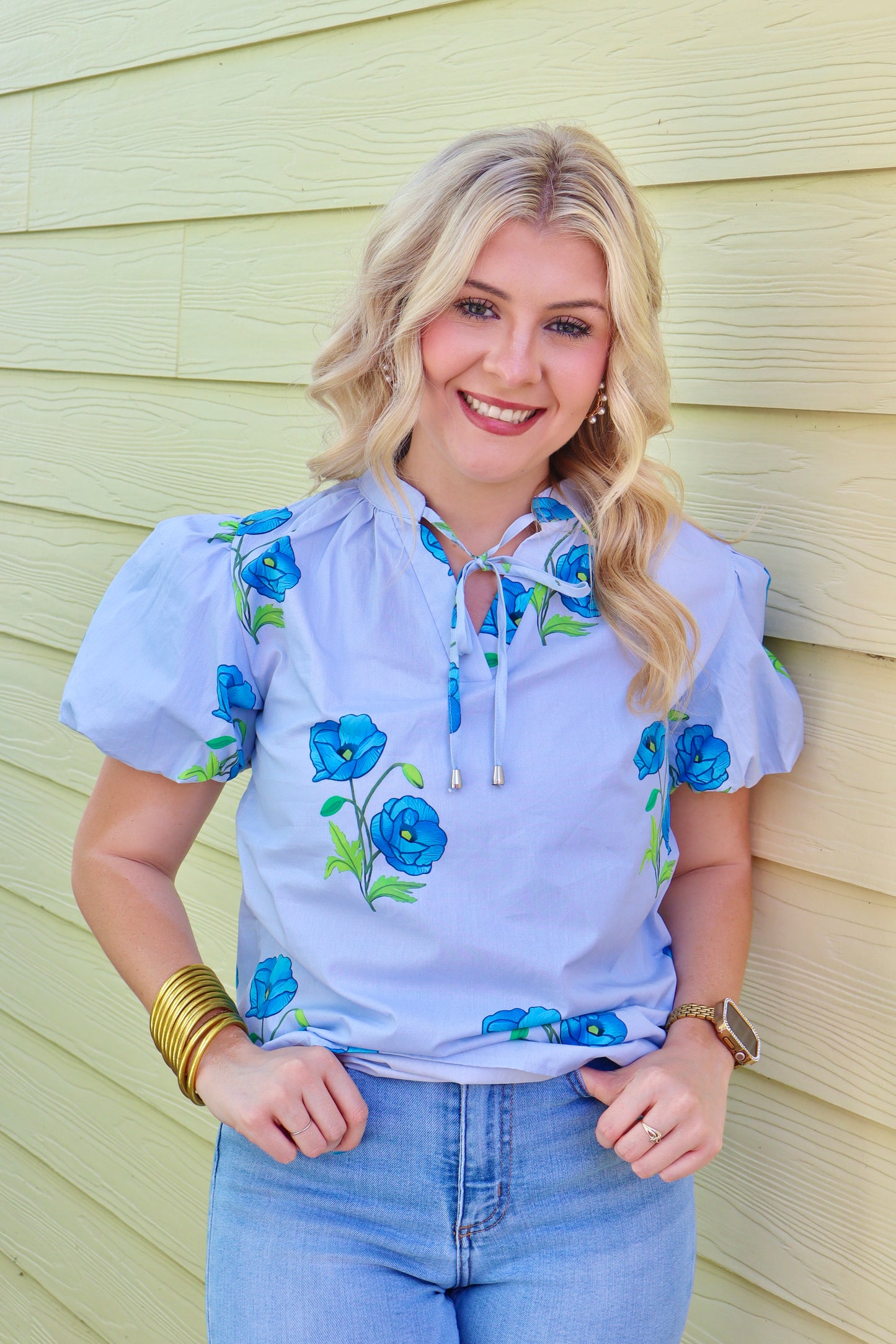 Sky blue floral print tie split neck blouse with short puff sleeves by Modern Grace, featuring a stylish and feminine design.