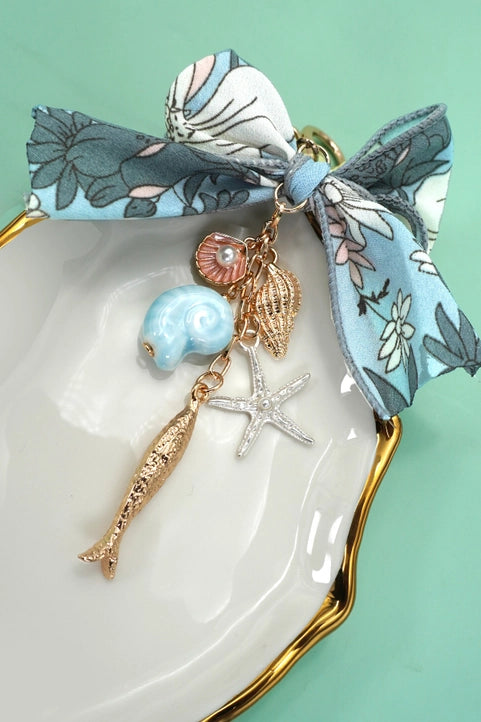 Ocean Porcelain Bag Charm by Modern Grace featuring fish, seashell, and starfish designs for accessories or bags.