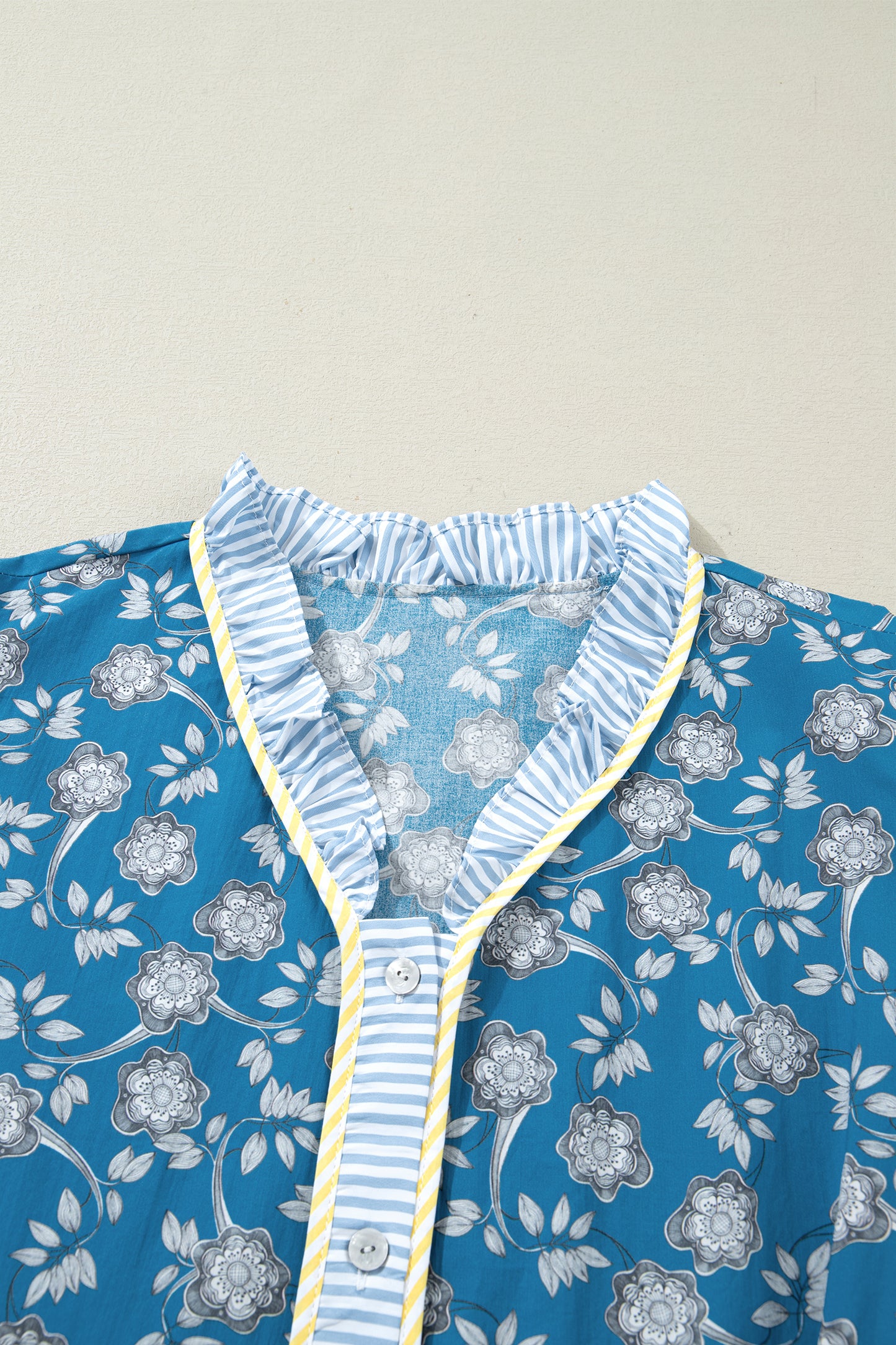Plus size floral print and striped patchwork dress by Modern Grace with ruffle hem, button front, and vibrant blue color.