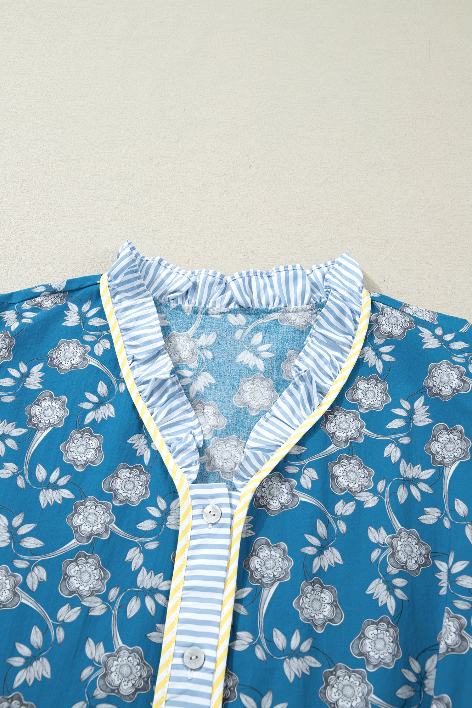 Plus size floral print and striped patchwork dress by Modern Grace with ruffle hem, button front, and vibrant blue color.