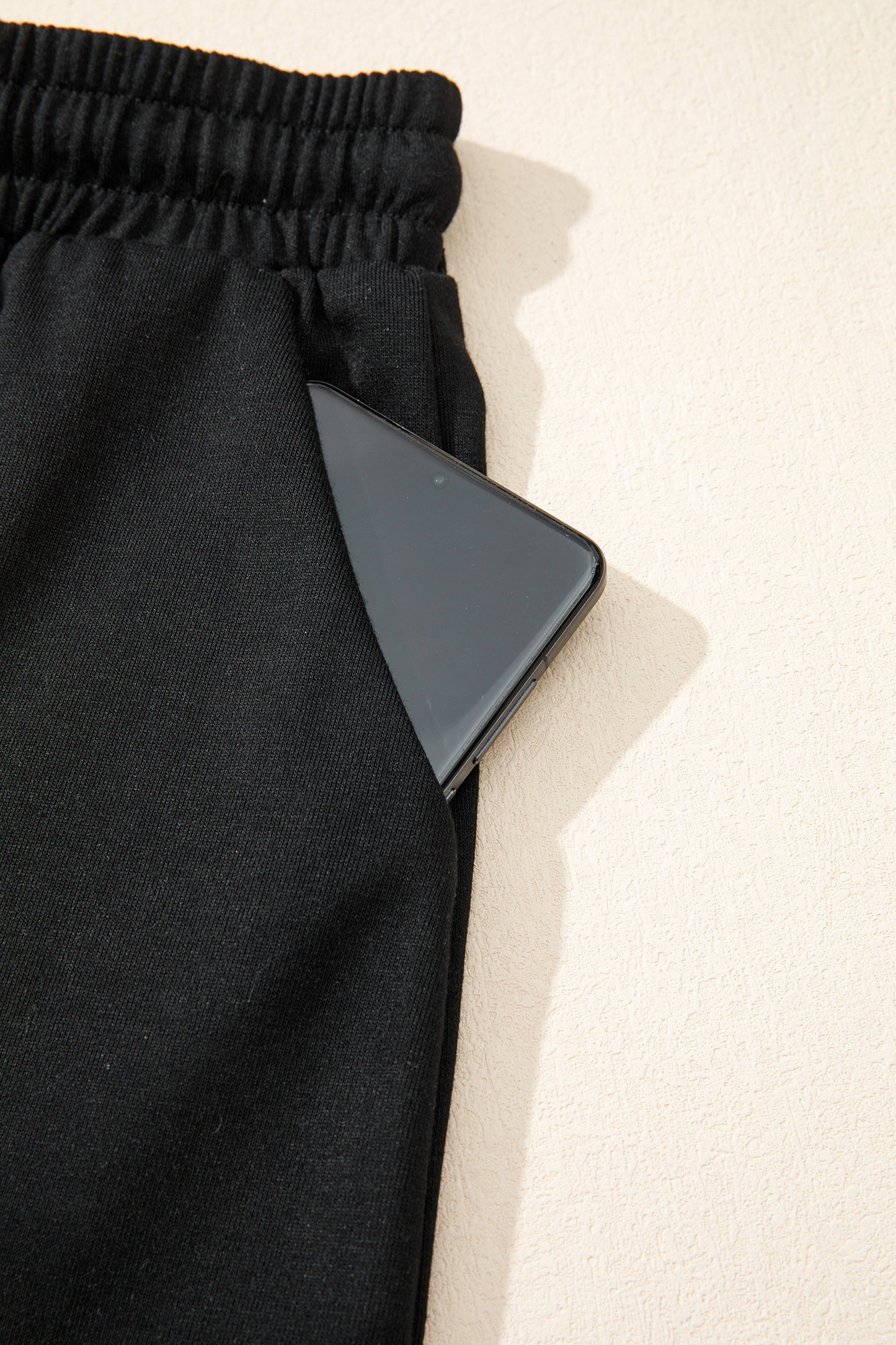 Modern Grace black leopard bow V-neck loose tee and drawstring shorts two-piece set, casual and stylish for relaxed wear.