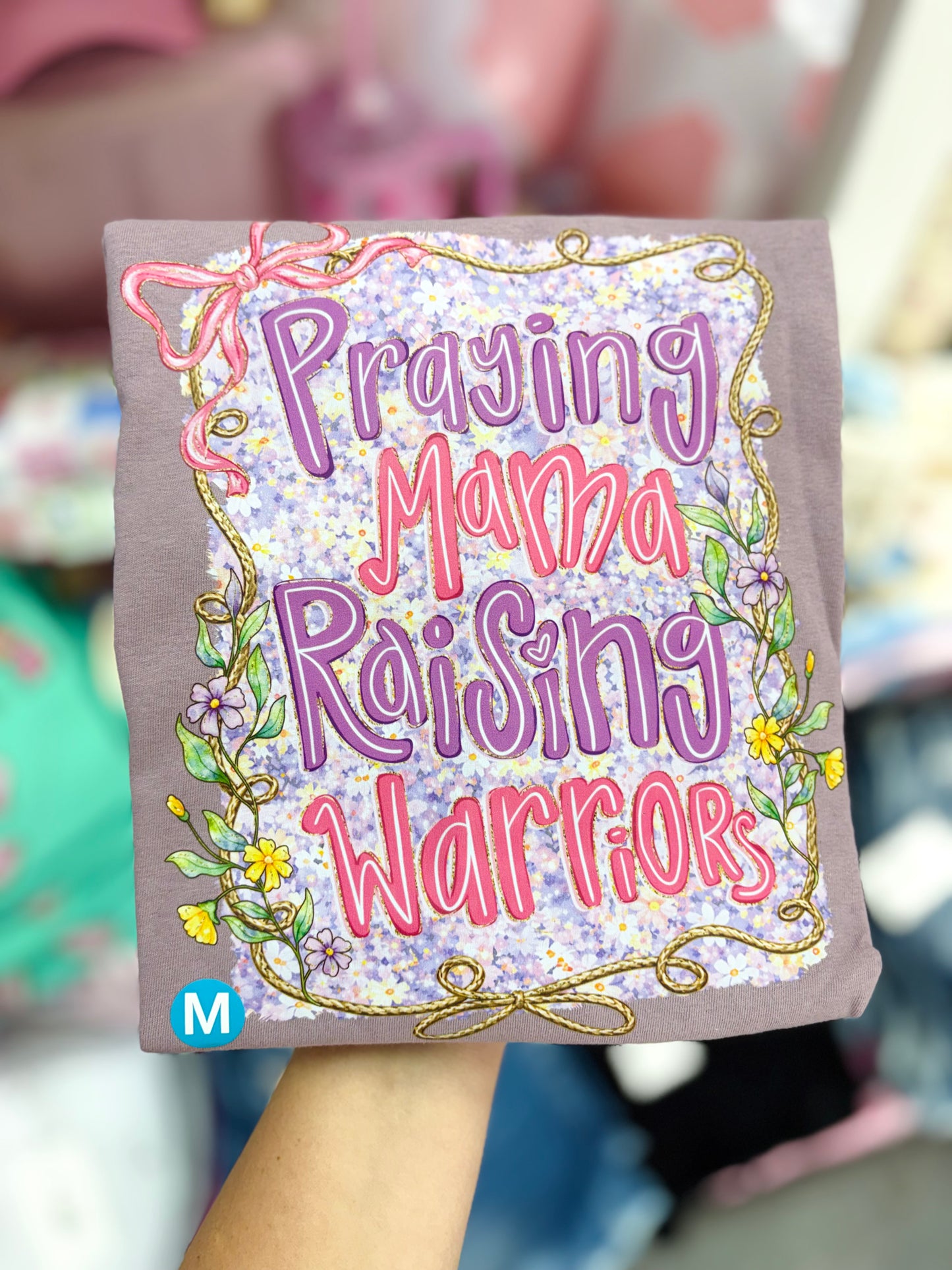 Modern Grace praying mama raising warriors short sleeve T-shirt featuring a heartfelt design on soft fabric.