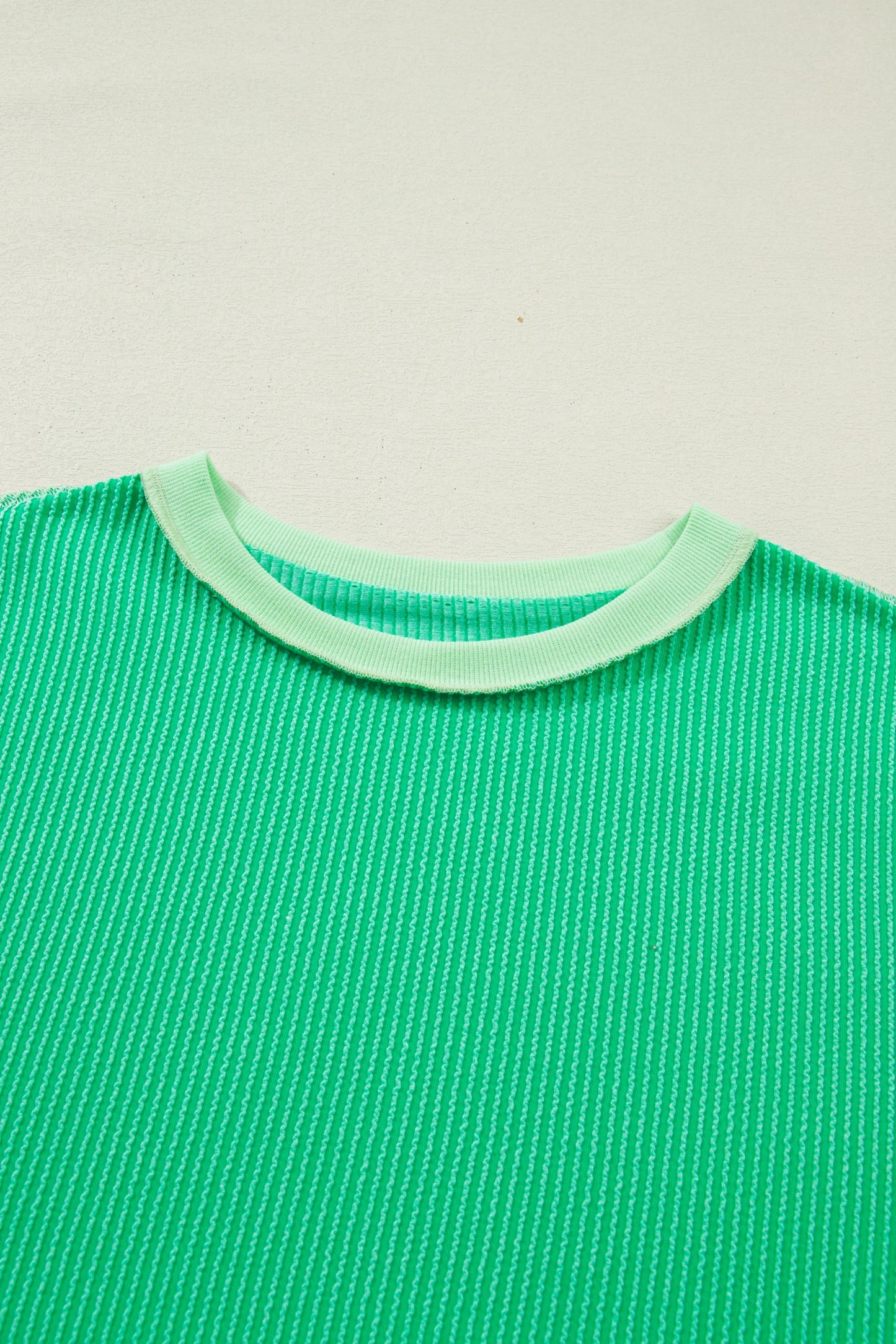 Mint green twisted rib knit tee with drop shoulder and uneven hem, stylish Modern Grace tops for casual wear.