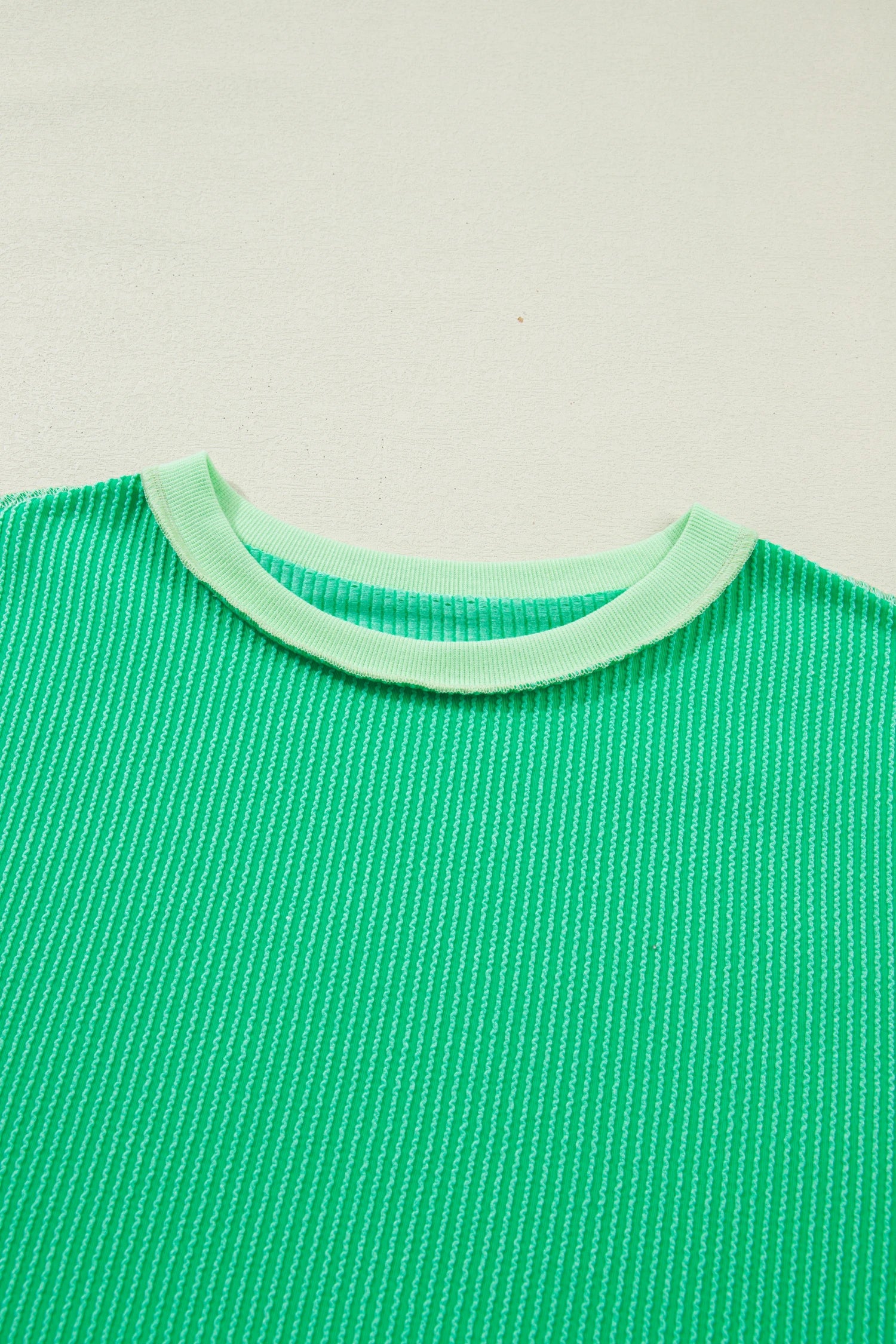 Mint green twisted rib knit tee with drop shoulder and uneven hem, stylish Modern Grace tops for casual wear.