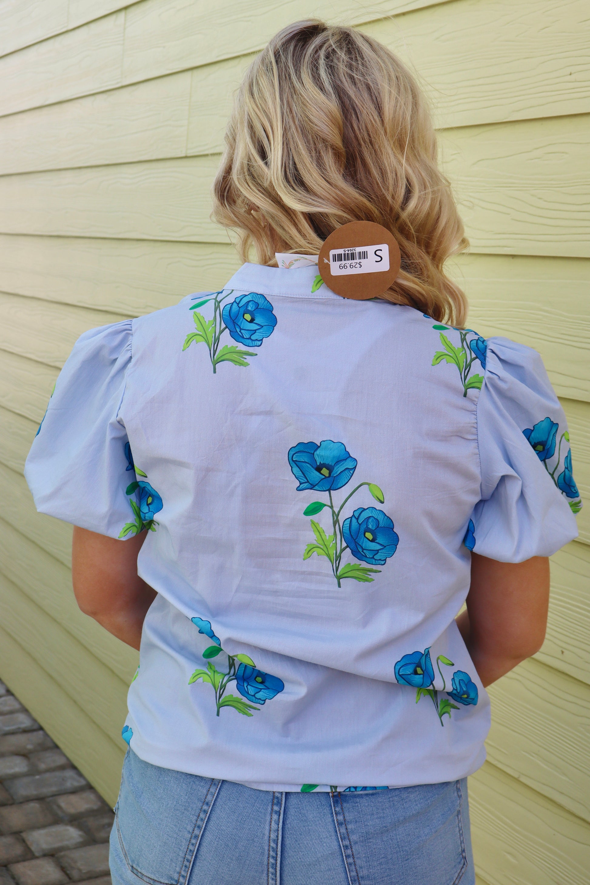 Sky blue floral print tie split neck short puff sleeve blouse by Modern Grace, featuring a feminine design and lightweight fabric.