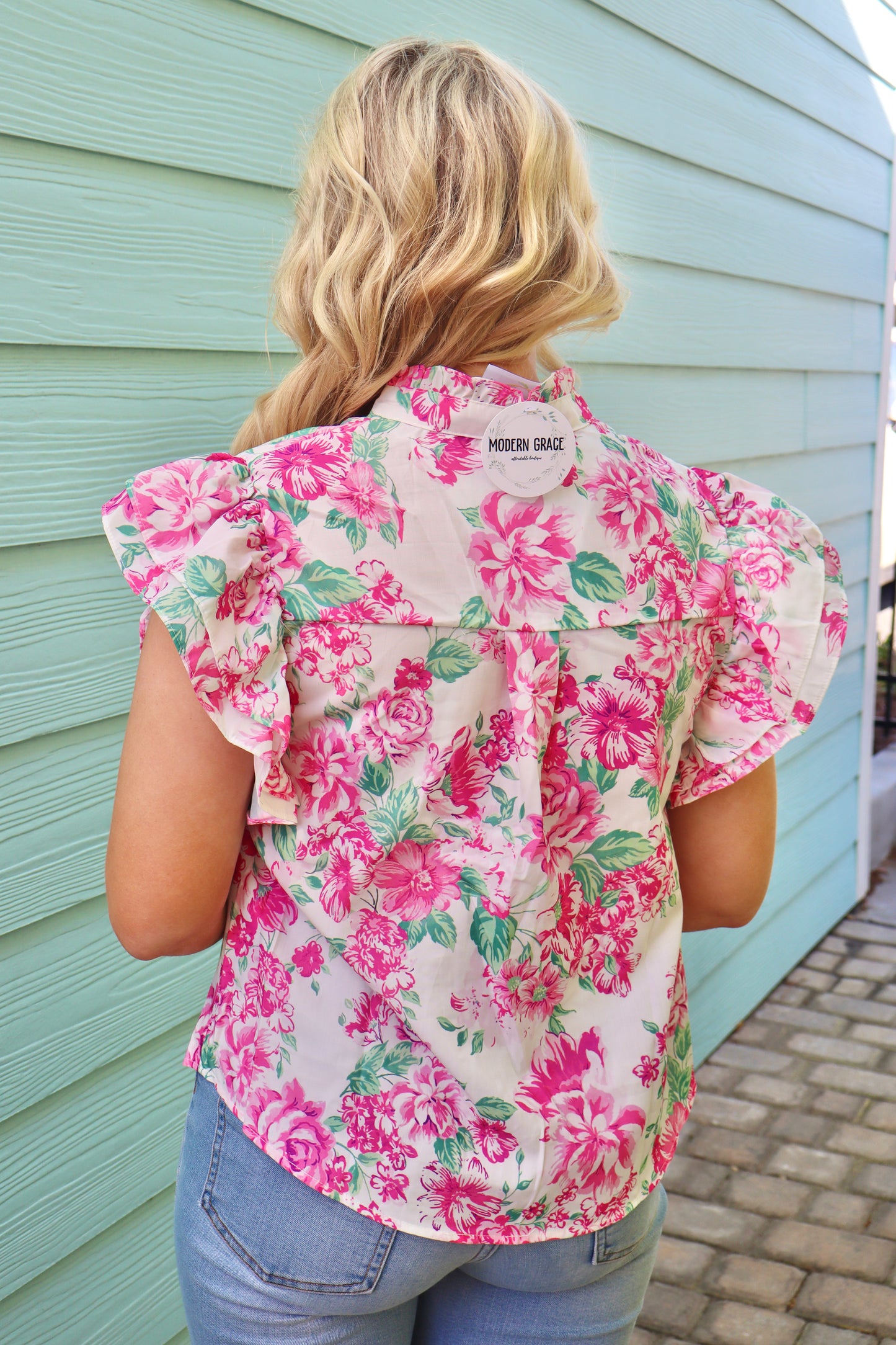 Pink floral print ruffle sleeve button-up shirt by Modern Grace, featuring frilly details and a stylish, feminine design.