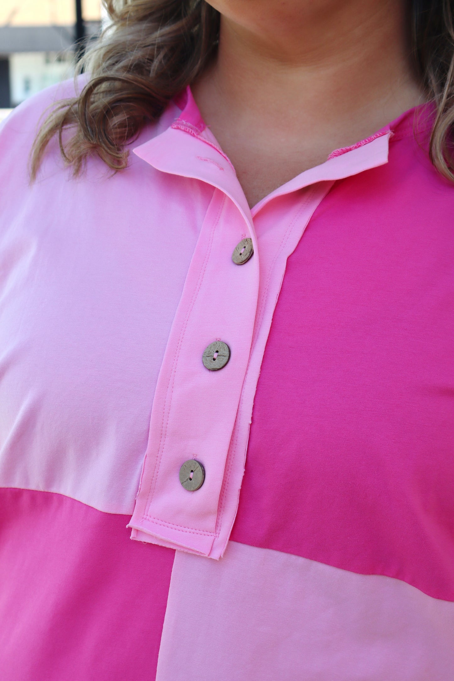 Plus size Modern Grace Henley top with bright pink colorblock patchwork, short sleeves, and button details.