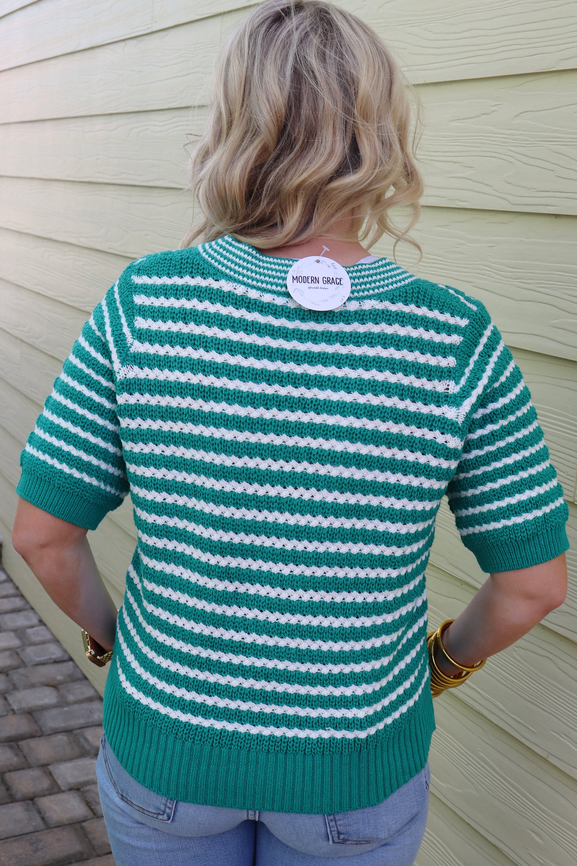 Green stripe short sleeve V-neck sweater with bow knot detail from Modern Grace, showcasing a casual and stylish knit top.