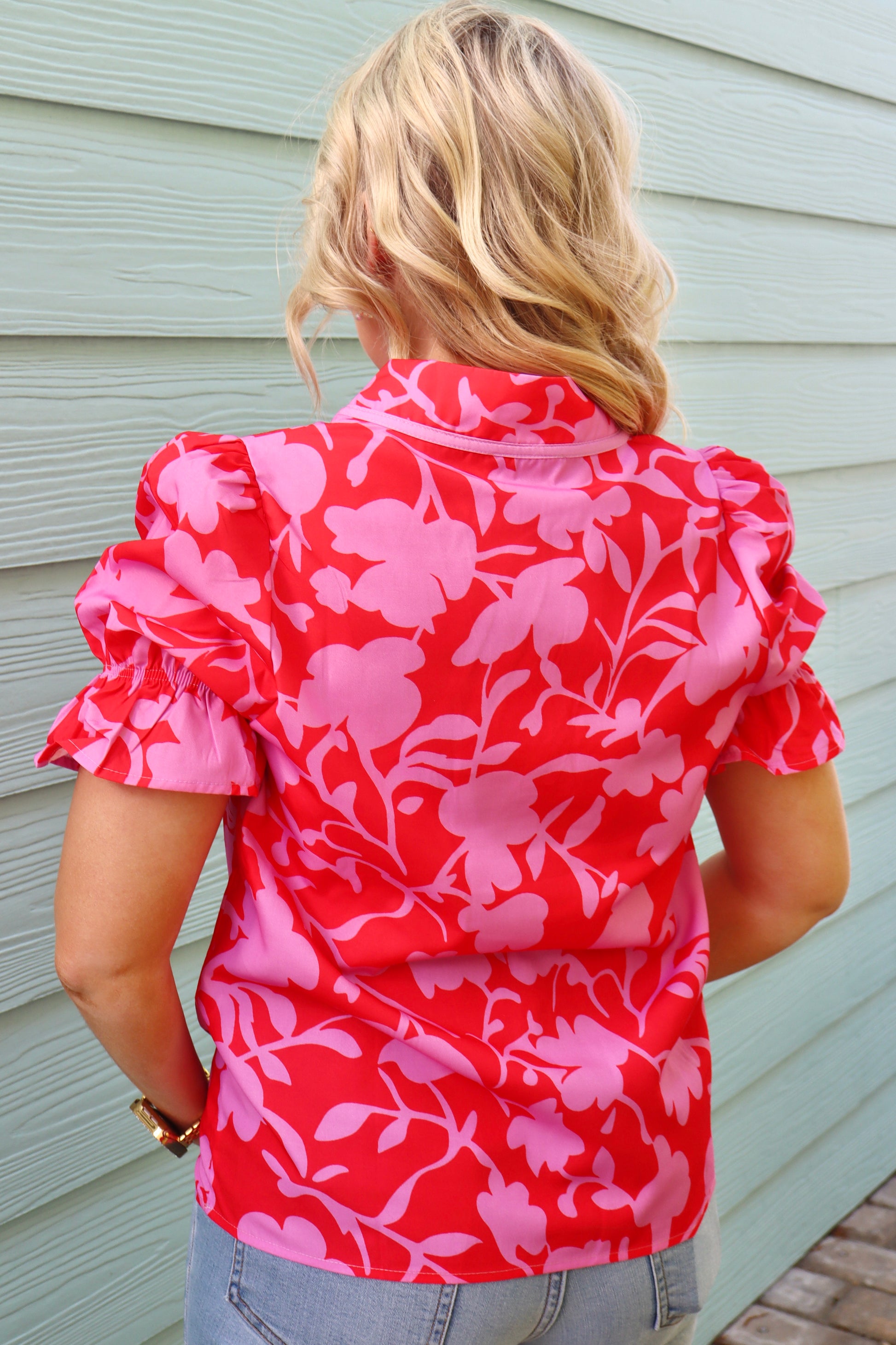 Modern Grace red floral split V-neck blouse with ruffled short sleeves and feminine design, perfect for casual or dressy occasions.