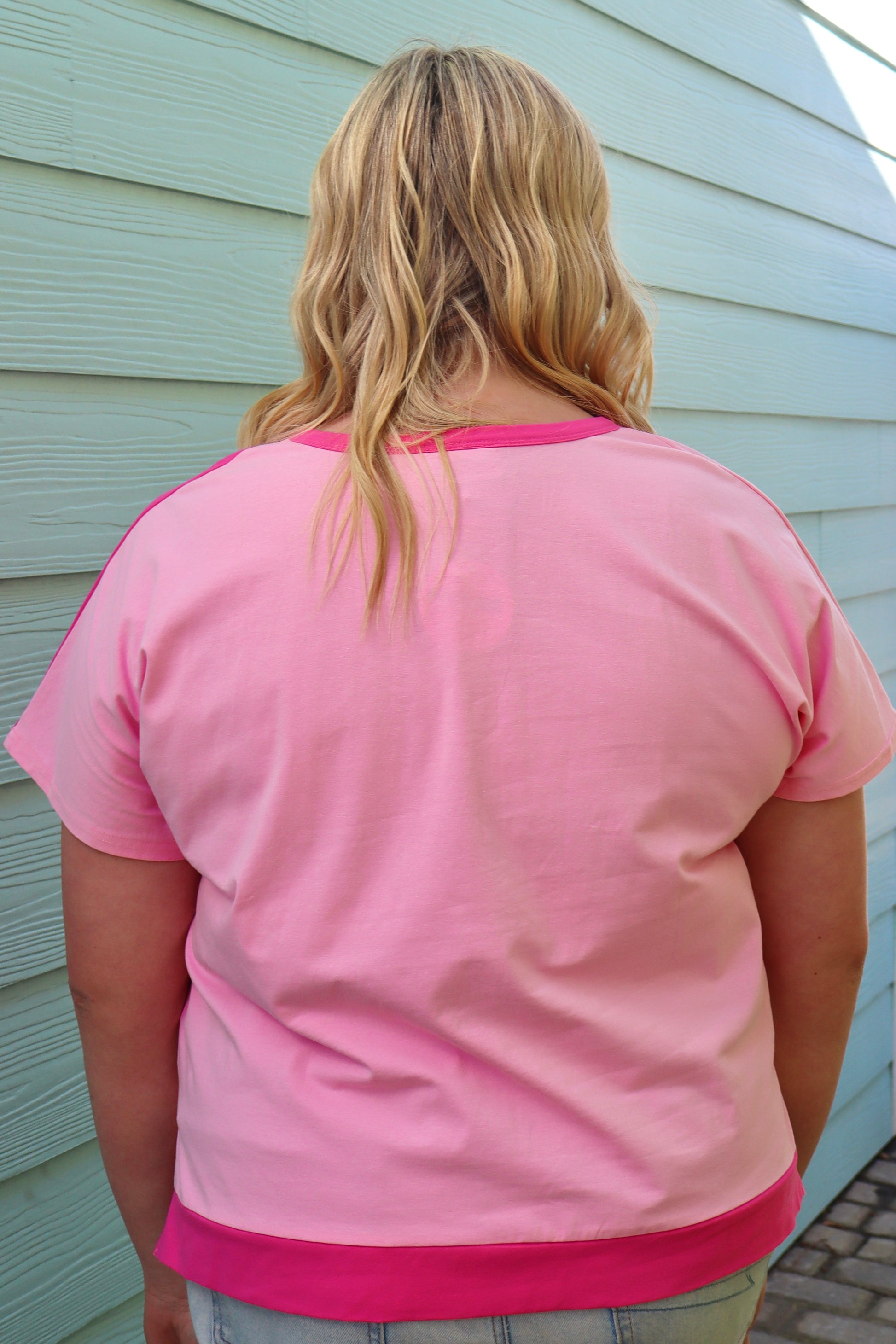 Plus size bright pink colorblock patchwork Henley top by Modern Grace with short sleeves and button details