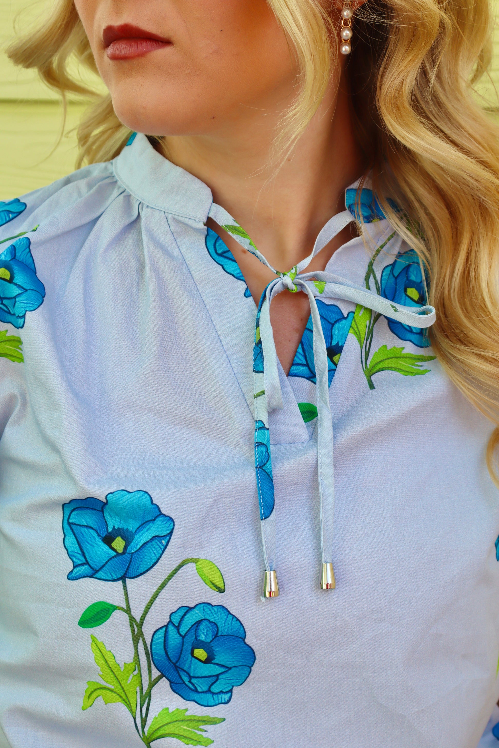 Sky blue floral print tie split neck blouse with short puff sleeves by Modern Grace, showing front view of the stylish top.