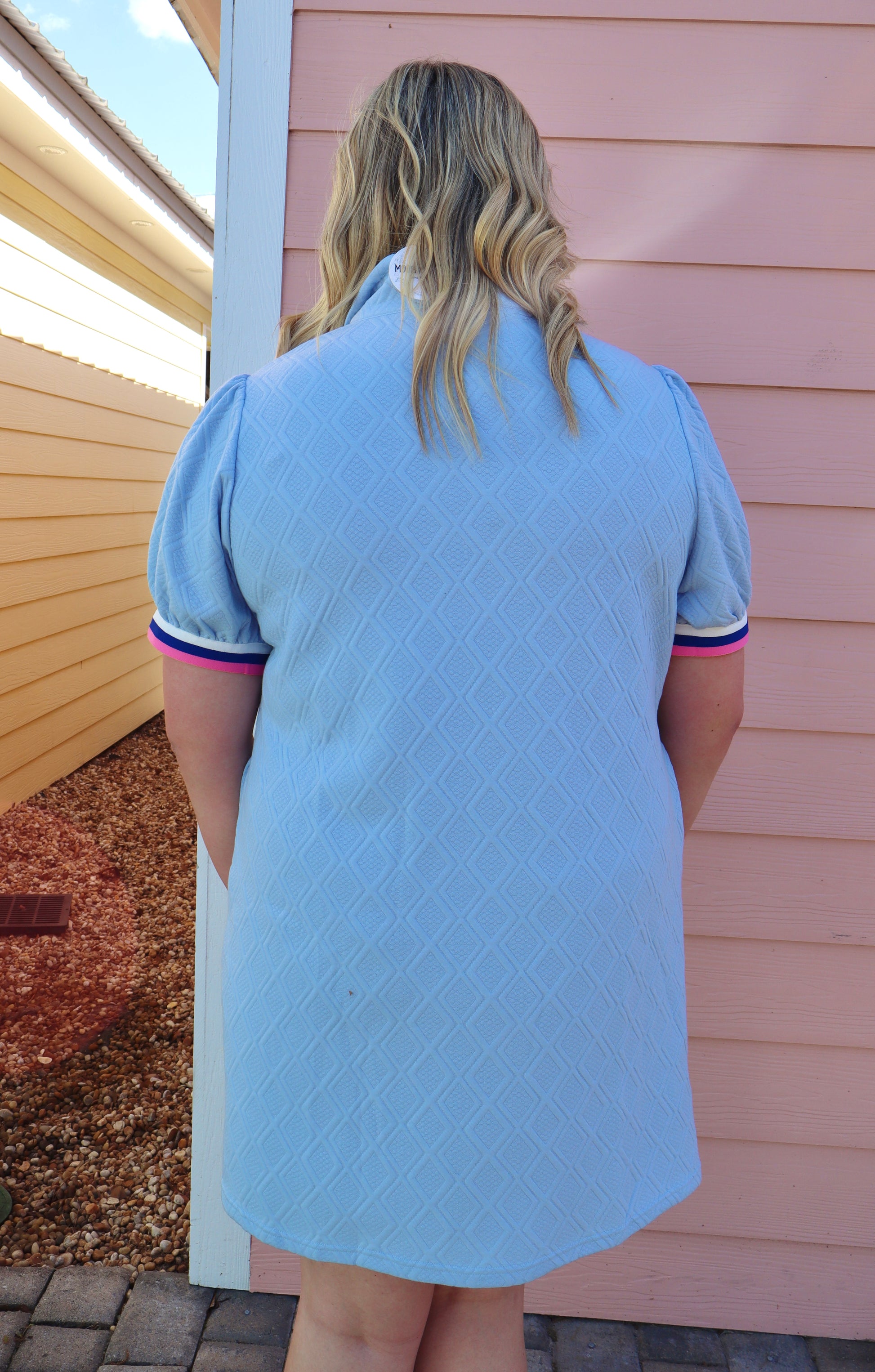 Modern Grace curvy blue T shirt dress with striped trim, zipped stand collar, textured puff sleeves, and a fitted silhouette.