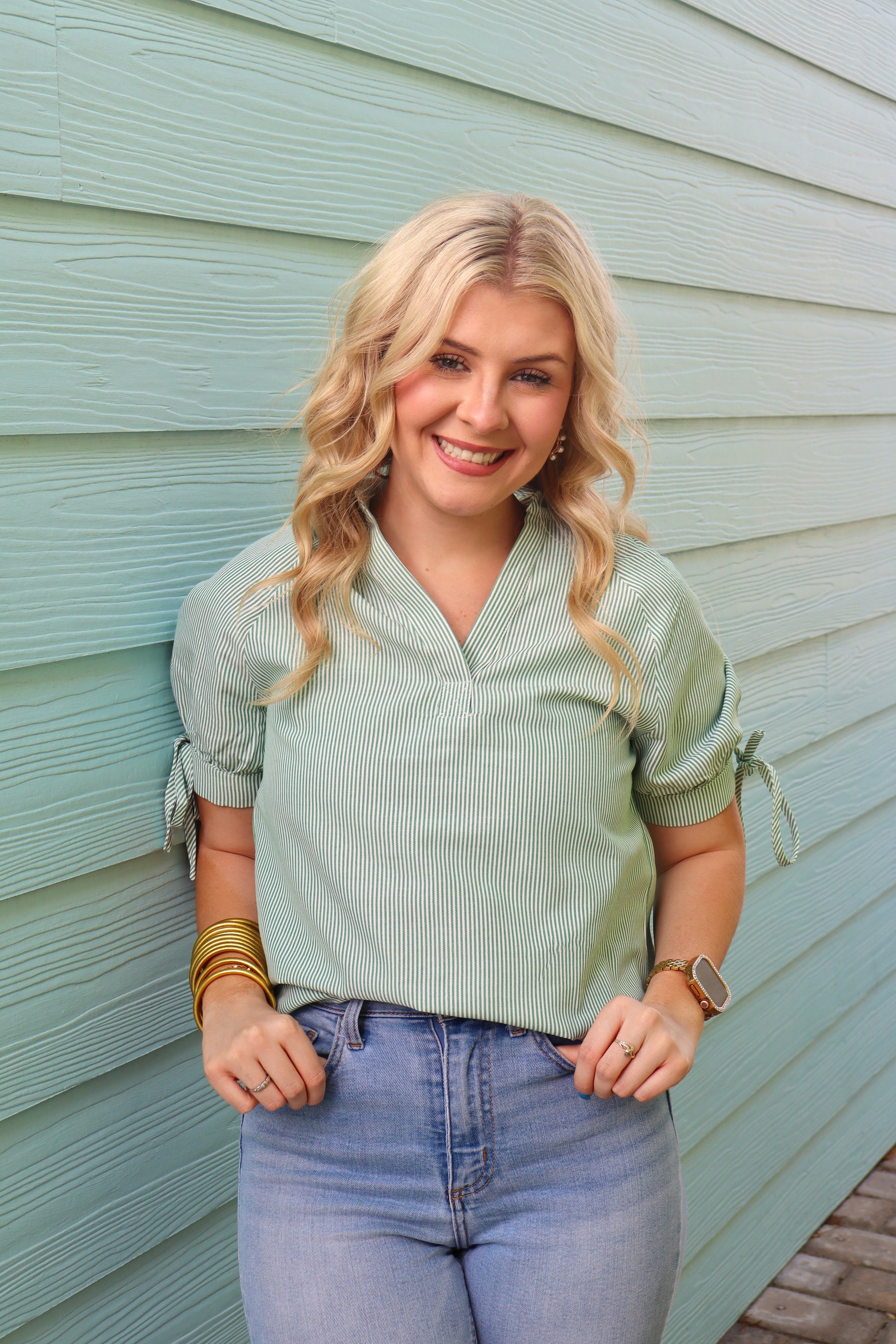 Green striped print collared blouse with split neck and half sleeves, by Modern Grace, shown on a hanger.