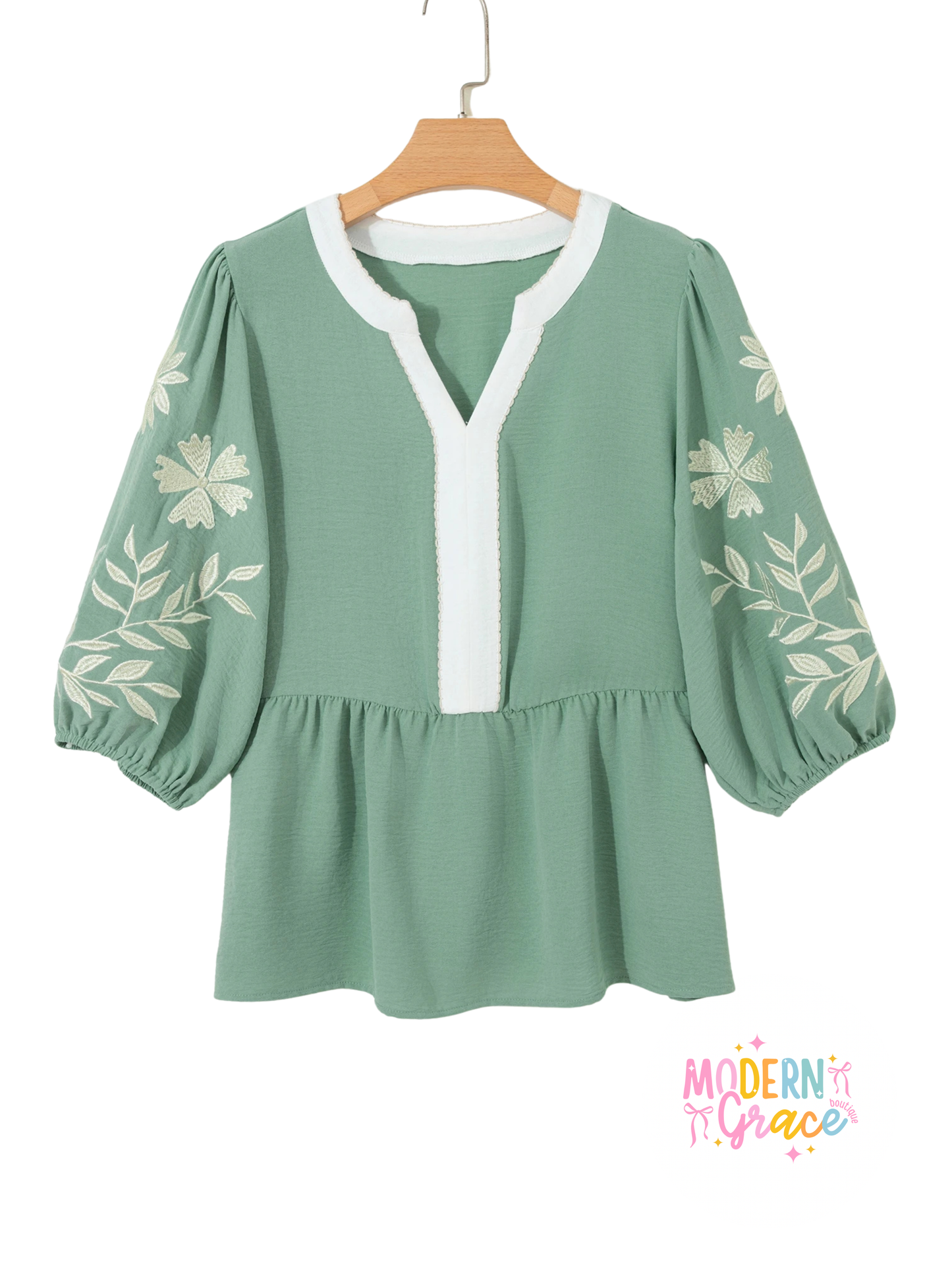 Sage green color block patchwork babydoll blouse with V-neck, embroidered details, and puff sleeves by Modern Grace.